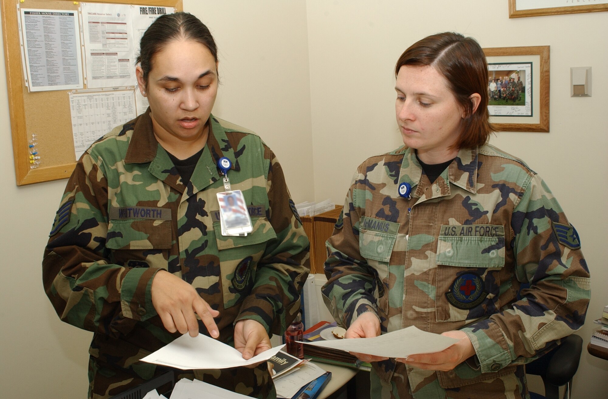 Staff Sergeant Sharon Whitworth, 341st Medical Support Squadron, or MDSS patient administrator and Staff Sergeant Christena McManus, 341st MDSS NCOIC TriCare operations and patient administration flight, discuss paperwork in Sergeant McManus’s office at the Malmstrom Clinic following an appreciation week for medical administration and records personnel called “4A Appreciation Week.” (U/S/ Air Force photo/Airman 1st Class Dillon White)                               