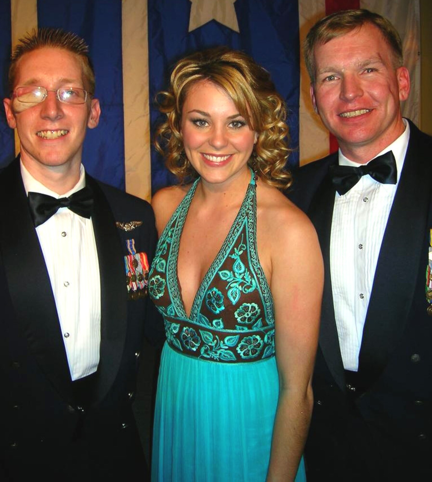 Tech. Sgt. Christian MacKenzie (right) and Staff Sgt. Eric Ezell pose with Miss America 2007 Lauren Nelson at the USO of Metro Washington Area Annual Awards Banquet earlier this year. Sergeant Ezell was the Air Force honoree during the event because of wounds he received in Iraq. Sergeant MacKenzie attended as his special guest because of the support he provided Sergeant Ezell during his recovery at Walter Reed Army Medical Center in Washington, D.C. (Courtesy photo)