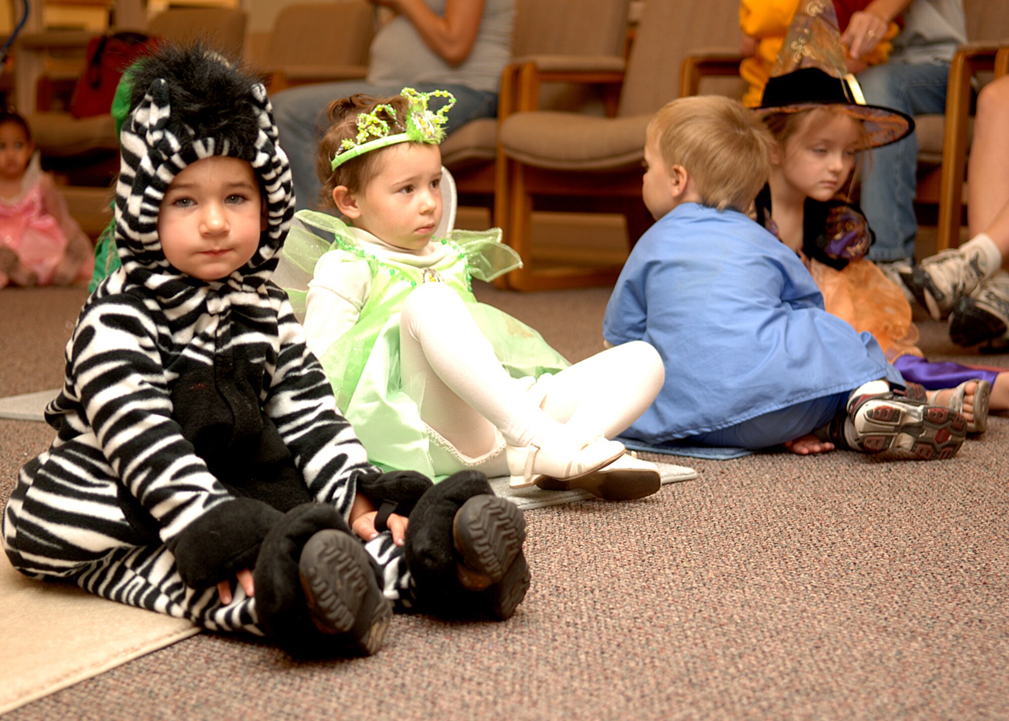 Preschoolers from the Child Development Center sit and listen in costume during a special Halloween Preschool Story Time on Holloman AFB, N.M., Oct. 31, 2007.  Preschool story time happens every Wednesday at the Holloman library. (U.S. Air Force photo by Airman 1st Class John D. Strong II)  