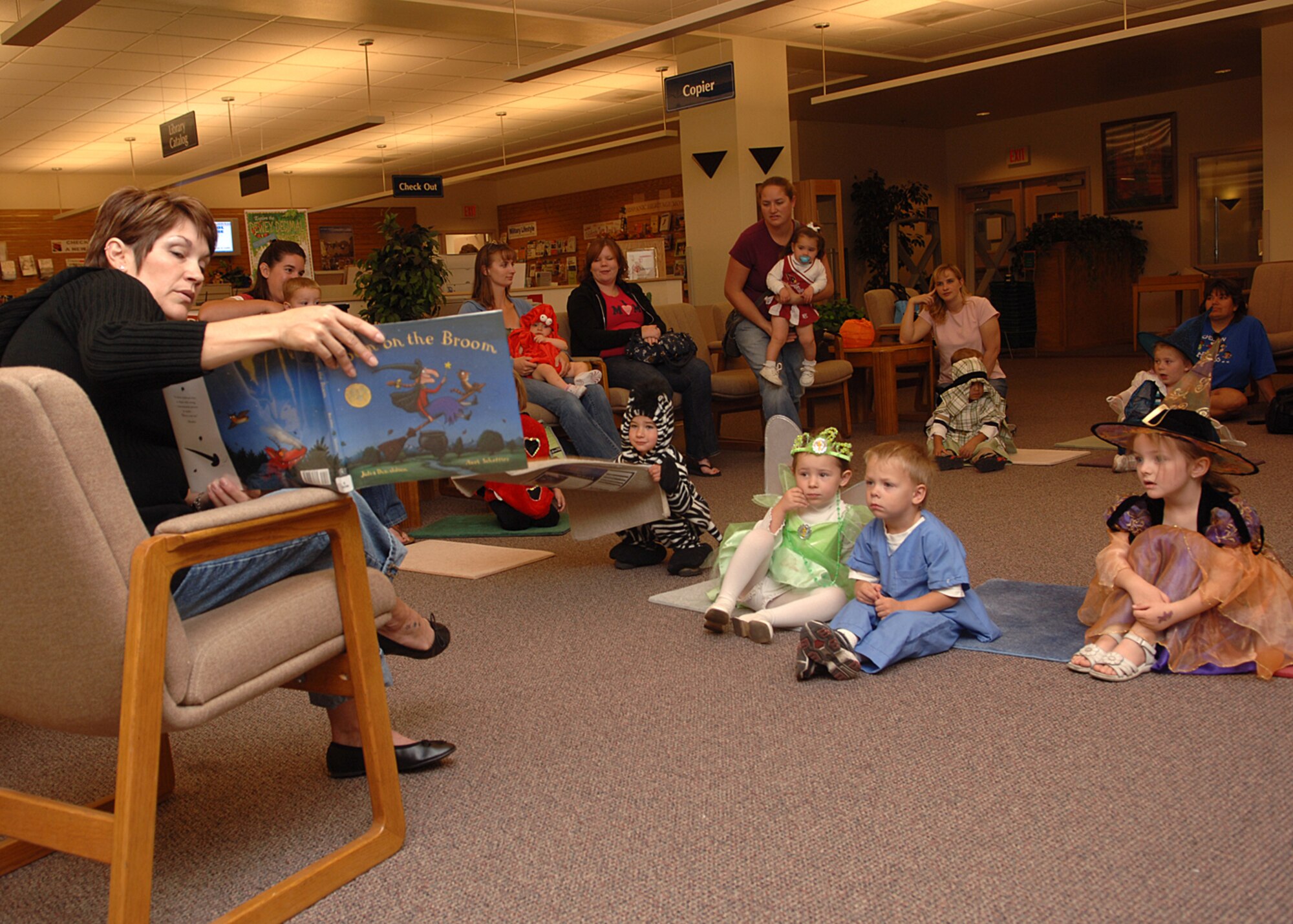 Preschoolers from the Child Development Center sit and listen in costume during a special Halloween Preschool Story Time on Holloman AFB, N.M., Oct. 31, 2007.  Preschool story time happens every Wednesday at the Holloman library. (U.S. Air Force photo by Airman 1st Class John D. Strong II)  