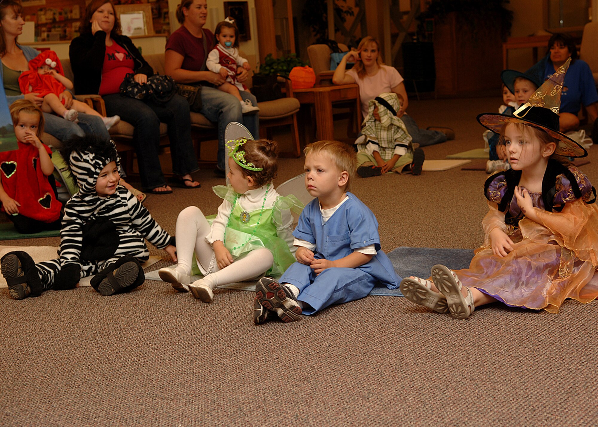 Preschoolers from the Child Development Center sit and listen in costume during a special Halloween Preschool Story Time on Holloman AFB, N.M., Oct. 31, 2007.  Preschool story time happens every Wednesday at the Holloman library. (U.S. Air Force photo by Airman 1st Class John D. Strong II)  
