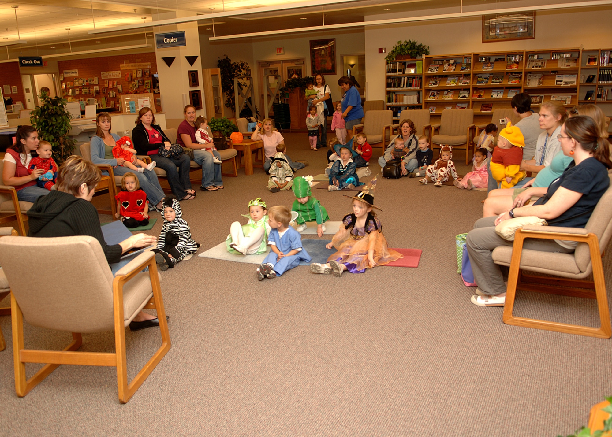 Preschoolers from the Child Development Center sit and listen in costume during a special Halloween Preschool Story Time on Holloman AFB, N.M., Oct. 31, 2007.  Preschool story time happens every Wednesday at the Holloman library. (U.S. Air Force photo by Airman 1st Class John D. Strong II)  