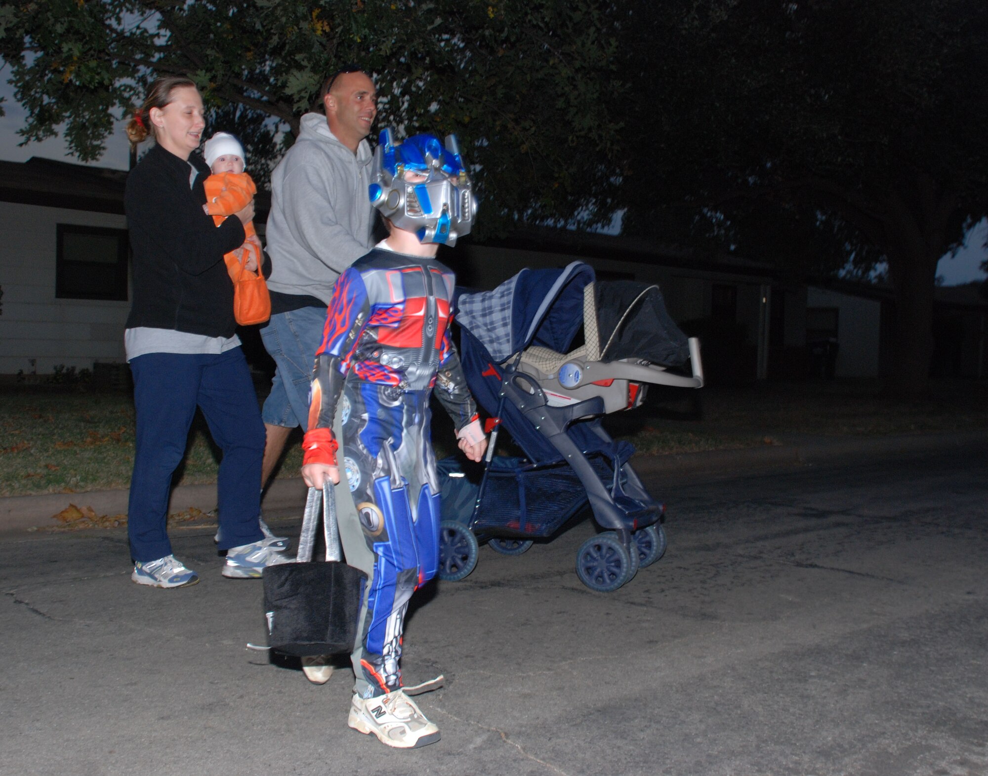 Staff Sgt. Chris Dippold, an instrutor with the 362nd Training Squadron, and his wife Nicole Dippold walk with their children Chris and Carlie while trick-or-treating Oct. 31 in Wherry Housing. (U.S. Air Force photo/Airman 1st Class Jacob Corbin)