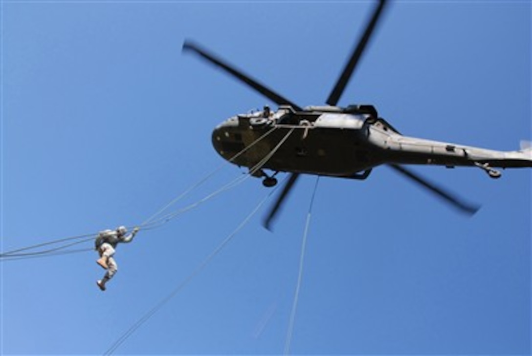 A U.S. Army soldier from the 101st Airborne Division (Air Assault) rappels from a UH-60 Black Hawk helicopter during air assault training at the Sabalauski Air Assault School at Fort Campbell, Ky., on Oct. 29, 2007.  