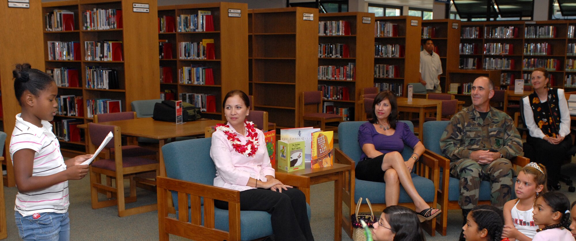 Vivian Aiona is jointed by Mrs. Irene Torres with elementaty school children at the Hickam Library. 