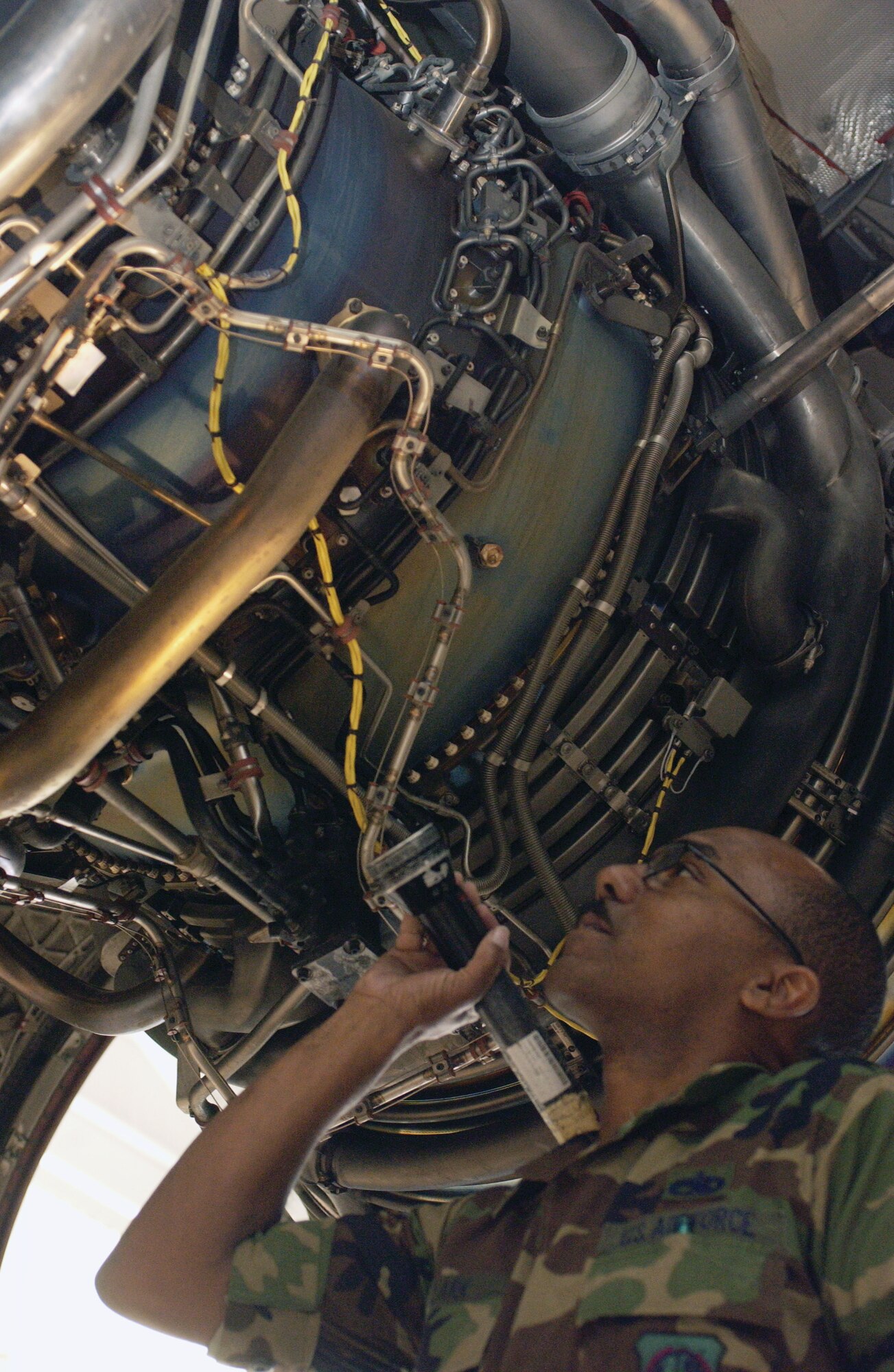 Technical Sgt. Harvey Clark, a jet engine propulsion mechanic with the 452nd MXS, inspects fires detection loops and sensors on a C-17 Globemaster III.  (U.S. Air Force photo by Amy Abbott)