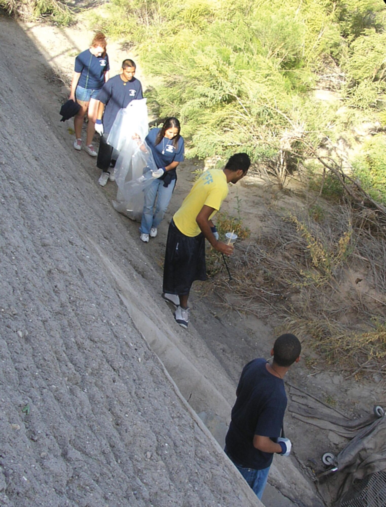Davis-Monthan teens pick up trash and debris at the Rillito River Park Wash as part of “Make a Difference! Day Oct. 27. The teens are part of Arizona’s Finest Keystone Club, an organization dedicted to leadership and development. (Photo by Diane Kephart) 