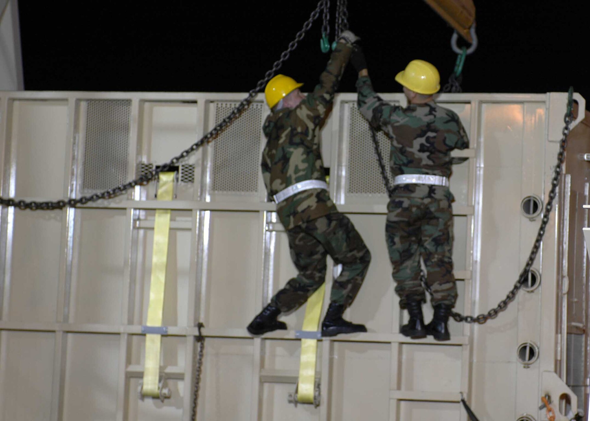 Airmen from the 60th Aerial Port Squadron work to load a crate holding Maggie the elephant's crate on to the truck that will take her to her new home near San Andreas Calif. Maggie was transported from the Alaska Zoo via a C-17 Globemaster III out of Elmendorf Air Force Base, Alaska, to live in a warmer climate. (U.S. Air Force photo/Staff Sgt. Candy Knight)