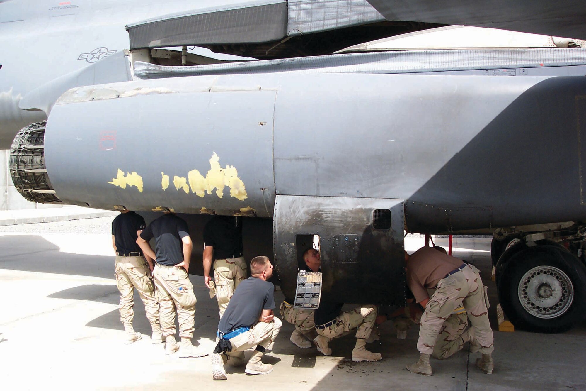 Enlisted members from the 654th Combat Logistics Support Squadron examine the damaged B-1 in a forward operating location within the U.S. Central Command area of responsibility. (Air Force photo)