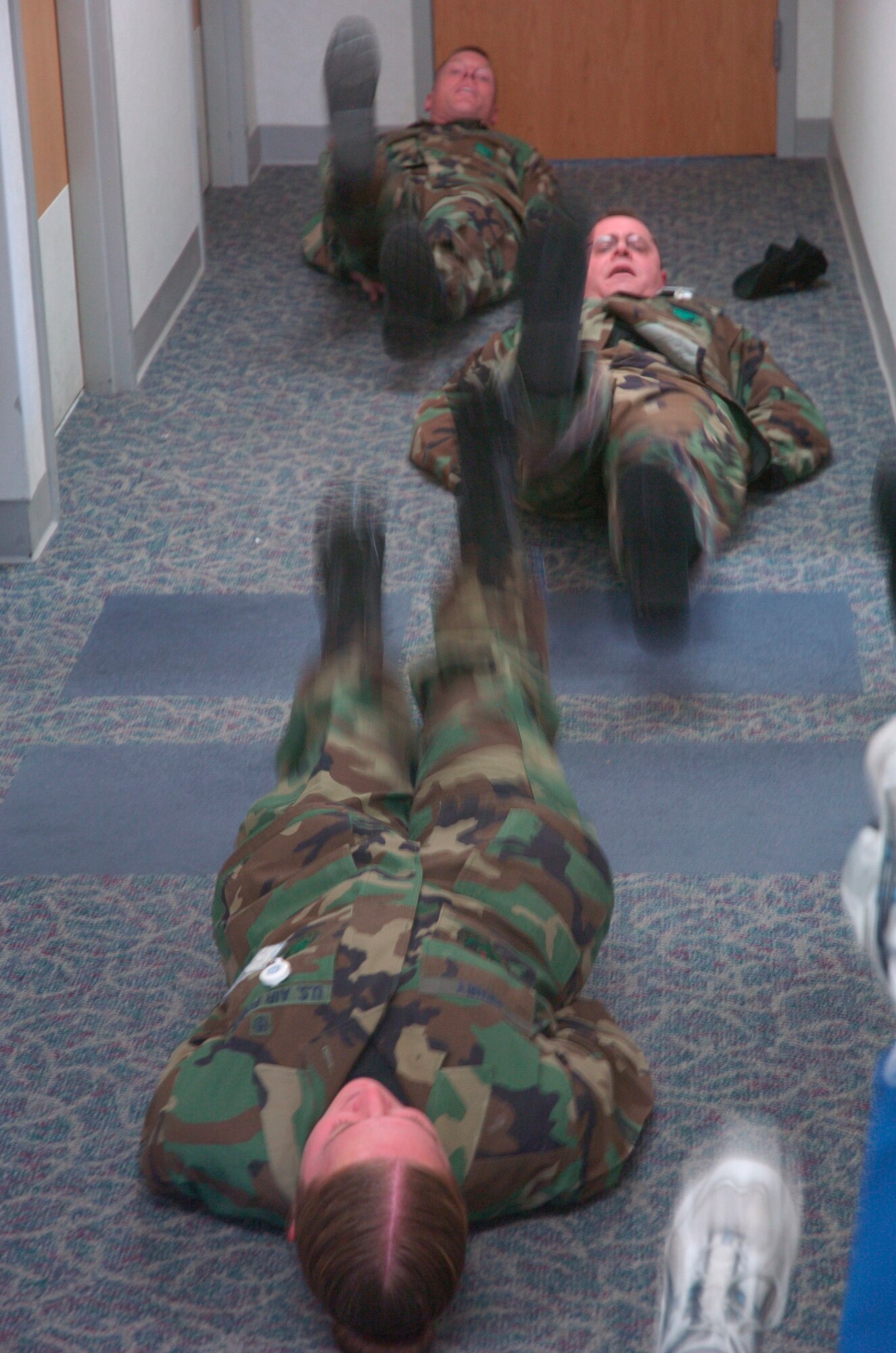 Chief Master Sgt. William Gurney, Ogden Air Logistics Center and 75th Air Base Wing command chief, executes leg lifts along with members from the 75th Medical Group during one of their routine exercise sessions.