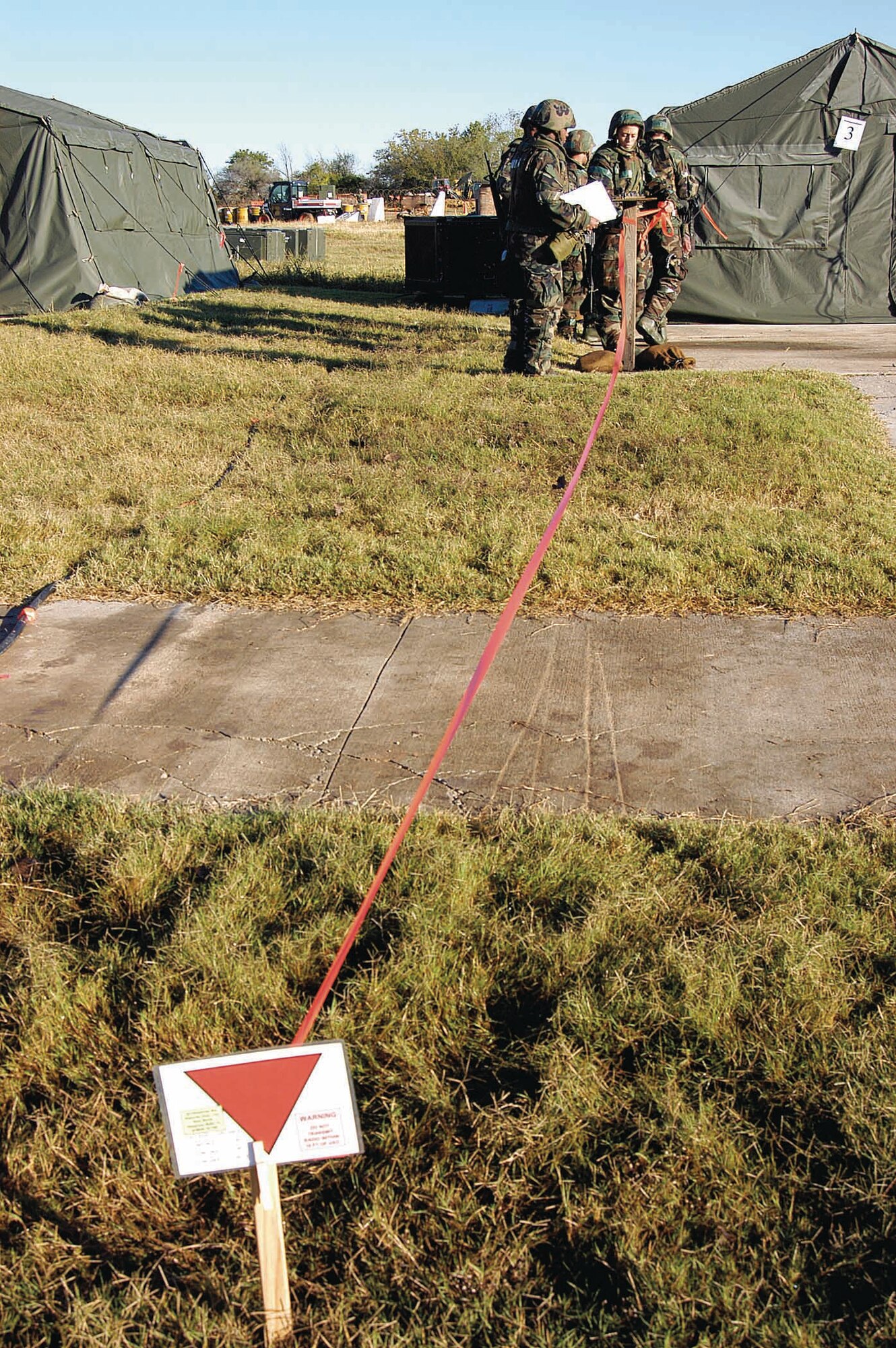 Airmen stake off an area in Glenwood to warn that unexploded ordnance has been found. The scenario occurred during a Resolute Warrior exercise sweep Oct. 23. (Air Force photo by Margo Wright) 