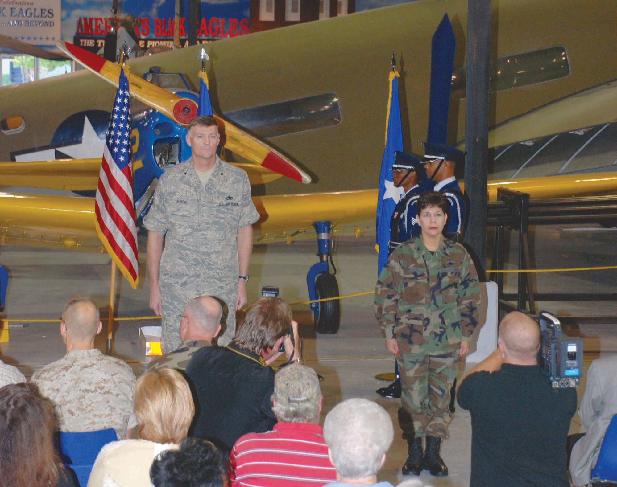 Brig. Gen. Andrew Busch, commander of Defense Supply Center Richmond, and Col. Madeline Lopez, incoming commander of Defense Logistics Agency Warner Robins, stand at attention Oct. 15 as an Air Force color guard enters and prepares to unfurl the DLA colors during an activation ceremony for the new aviation detachment at Robins AFB, Ga. (Air Force photo by Amy Clement) 