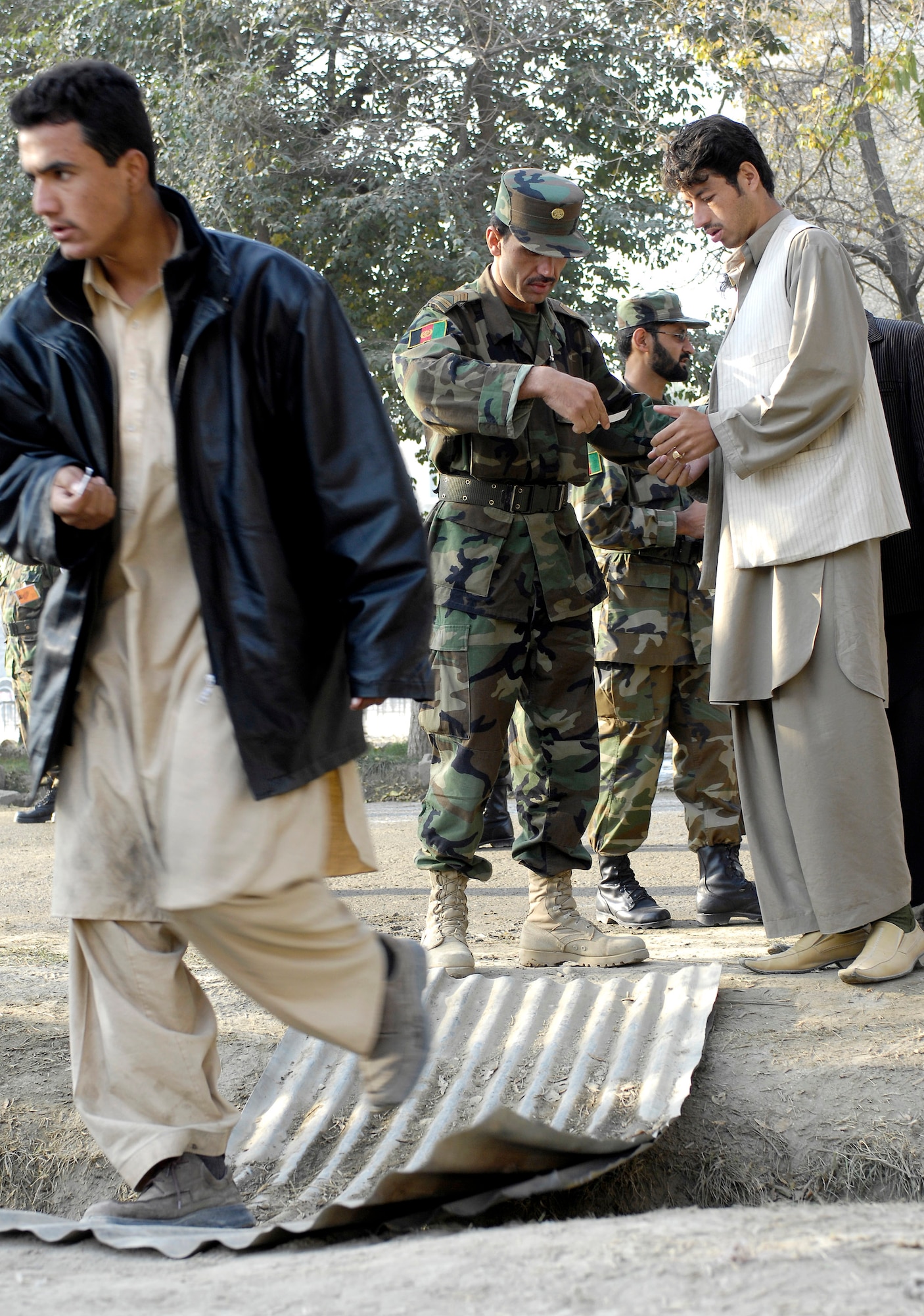 Sgt. Maj. Mohamad Alim checks the identification numbers of perspective cadets and directs them to their assigned groups at the Afghan National Army Academy, Kabul, Afghanistan, Oct. 25. There are more than 1,800 perspective cadets here, all hoping to be one of the approximately 300 chosen for the new freshman class. (U.S. Air Force photo/Staff Sgt. Brian Ferguson) 