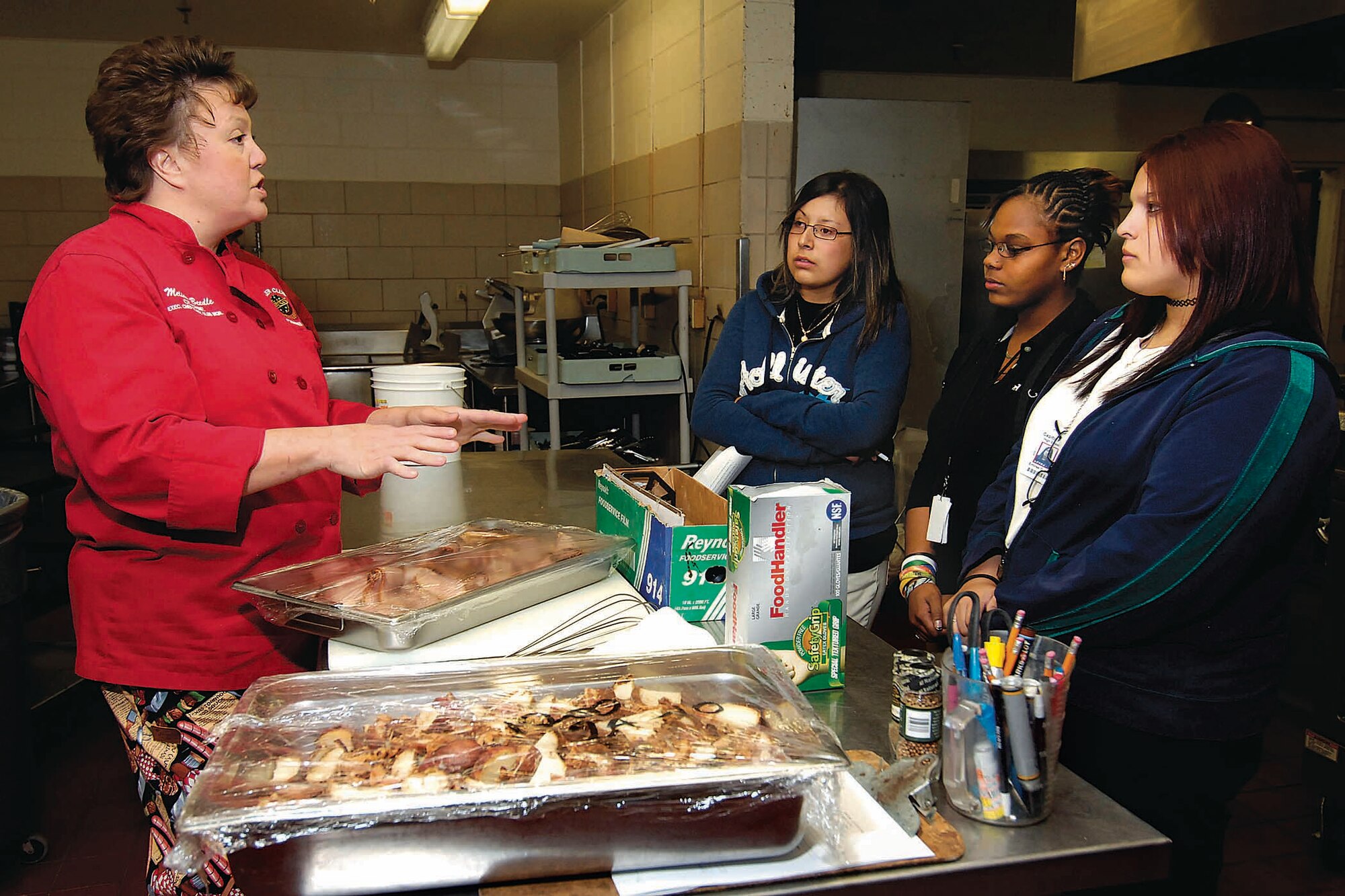 Capitol Hill High School students get the facts about life as a chef when they spent part of Oct. 25 with Tinker’s chef, Melissa Beedle. Elizabeth Gonzalez, Exzanty Moore, and Emirse Guerra, from left, were a few of the students who shadowed Tinker professionals to learn more about various careers during the Job Shadow day. (Air Force photo by Dave Faytinger)