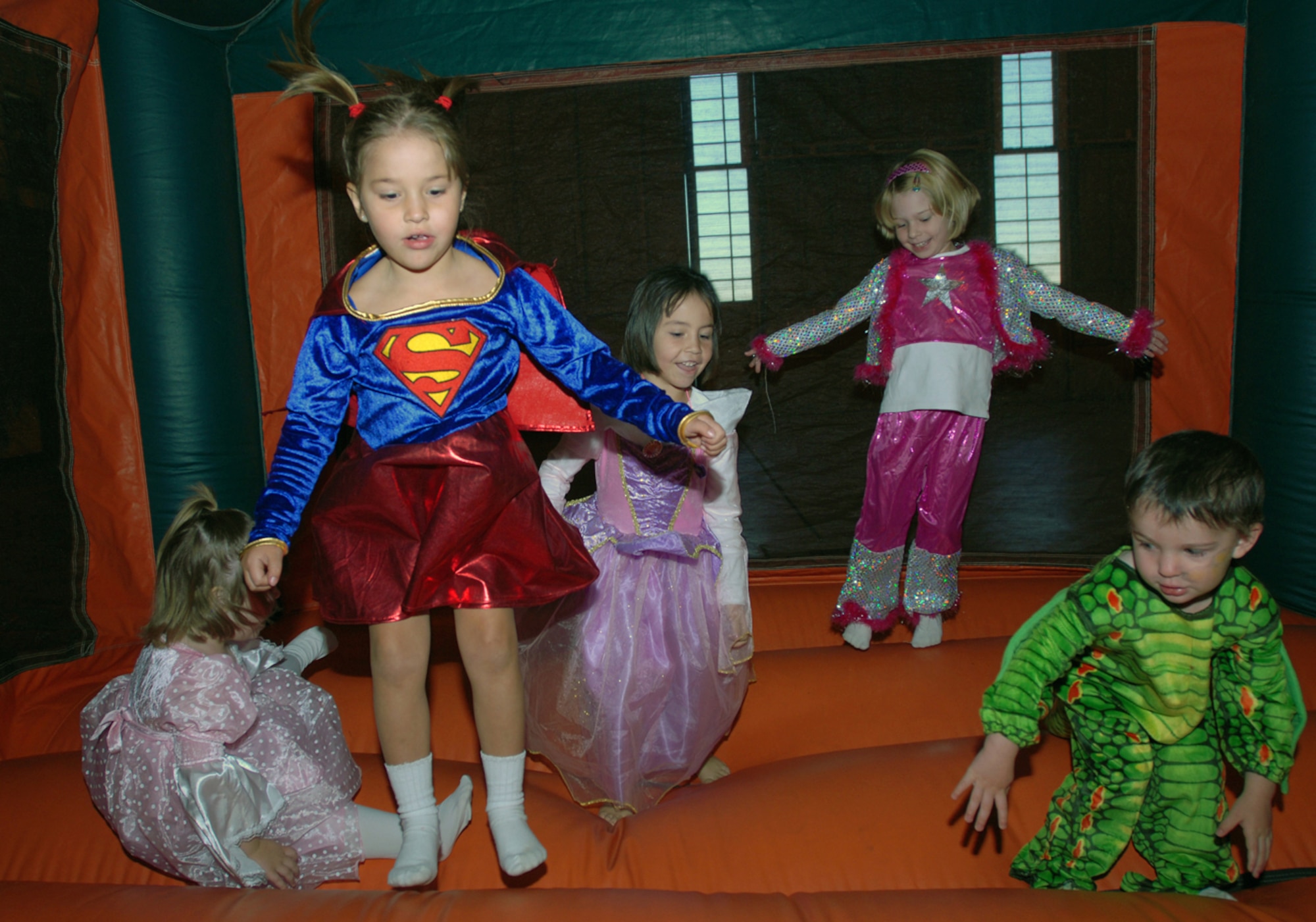BUCKLEY AIR FORCE BASE, Colo. -- Costume clad children jump in the moon bounce at the Fall Festival in Hangar 909 on Oct. 31. (U.S. Air Force photo by Airman 1st Class Michelle L. Cross Furtado)