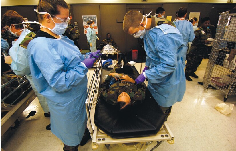 Doctors and medical technicians from the 79th Medical Group, assist patients from the mass casualty exercise during CAPITAL SHIELD 2007. (US Air Force/SSgt Suzanne Day)