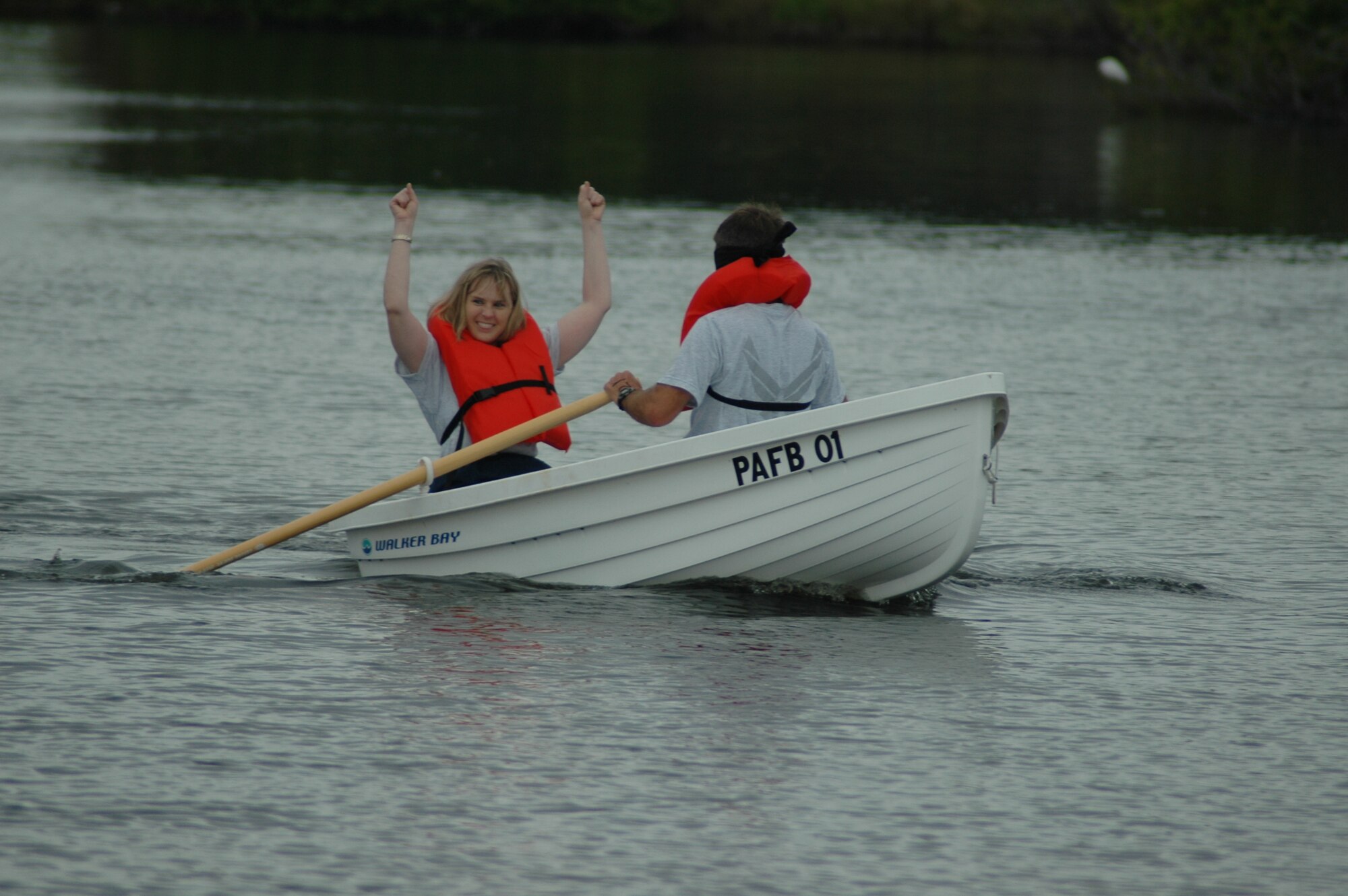Maj. Brande Walton guides a blindfolded Col. Stephen Butler, 45th Space Wing vice commander, during a dinghy race.