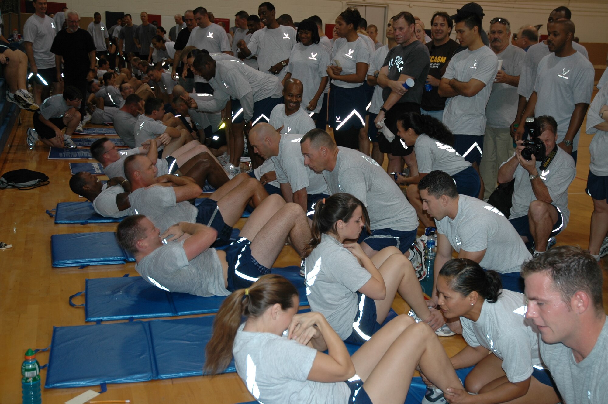 Members of the 45th Space Wing participate in a sit-up competition as part of the Wing's Sports Day Olympiad