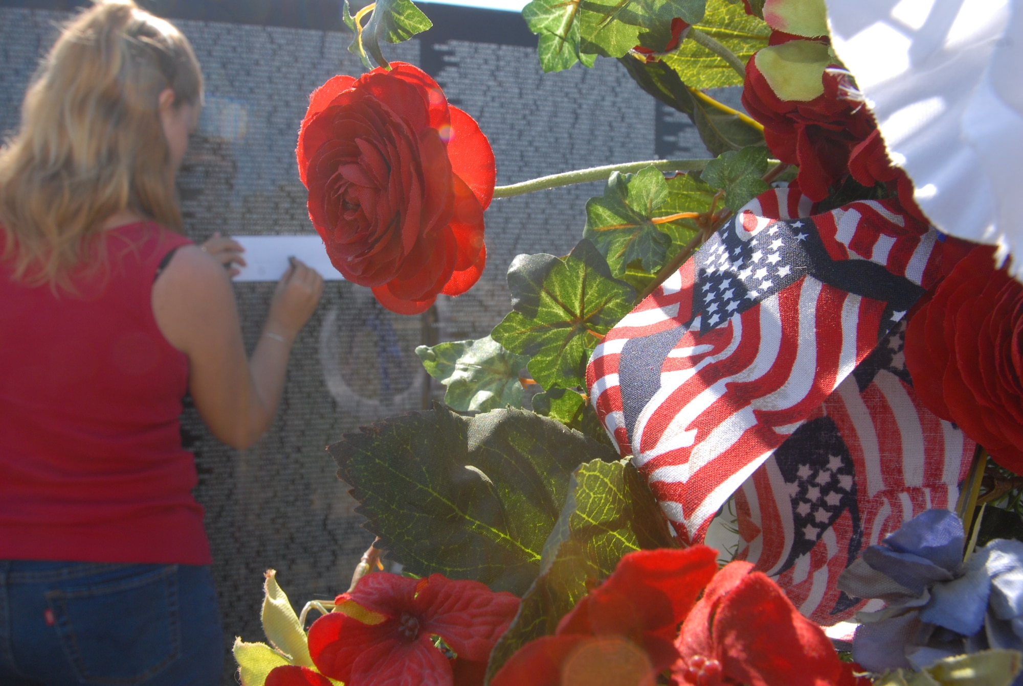 The Moving Wall, a half-scale replica of the Vietnam Veterans Memorial in Washington D.C. visited San Angelo last weekend. Here, a guest captures a name using rubbing chalk and paper. (U.S. Air Force photo by Staff Sgt. Angela Malek)