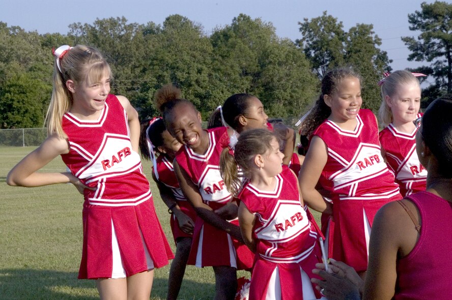 Youth cheerleaders stretch in preparation for a football game. Courtesy photo