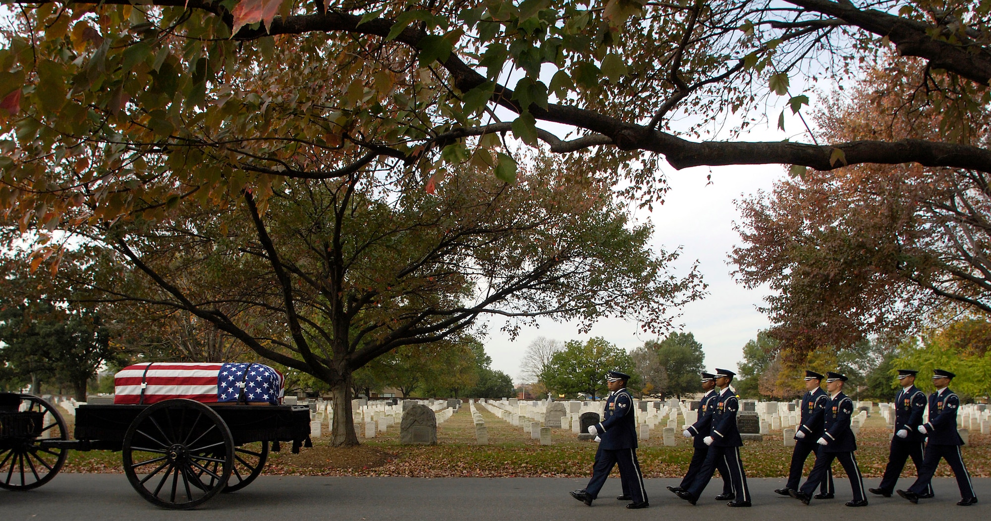 Members of the Air Force Honor Guard march behind a caisson during a military honors funeral ceremony Nov. 1 for retired Lt. Gen. Marvin McNickle at Arlington National Cemetery, Washington, D.C. Beginning Nov. 1, honor guards across the Air Force will change the way they perform retiree funerals.  (U.S. Air Force photo/Master Sgt. Jim Varhegyi)