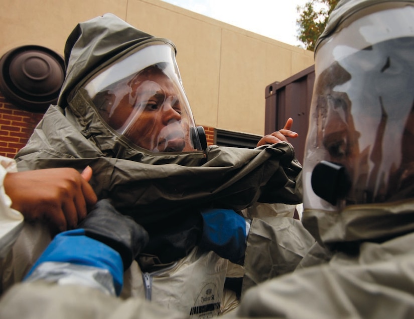 Airmen assist each other with putting on their decontamination suits properly during exercise CAPITAL SHIELD 2007 on Oct. 23. (US Air Force/SSgt Suzanne Day)