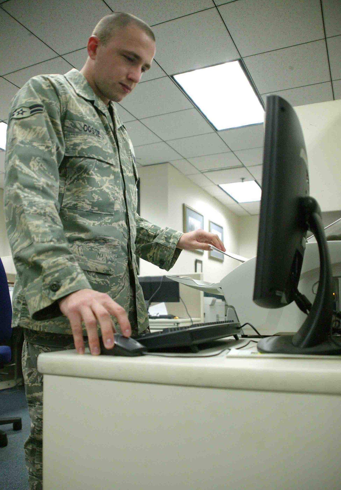 SHAW AIR FORCE BASE, S.C. -- Airman 1st Class Jereme Coste, 20th Comptroller Squadron travel pay technician, scans a travel voucher Oct. 31 for documentation and forwarding purposes. Shaw's finance team is being revamped throughout November and some technicians are relocating to the new Air Force Financial Service Center at Ellsworth AFB, S.D. The new center provides streamline processing and improves standardization and decreases transaction processing time. (U.S. Air Force photo/Staff Sgt. John Gordinier)