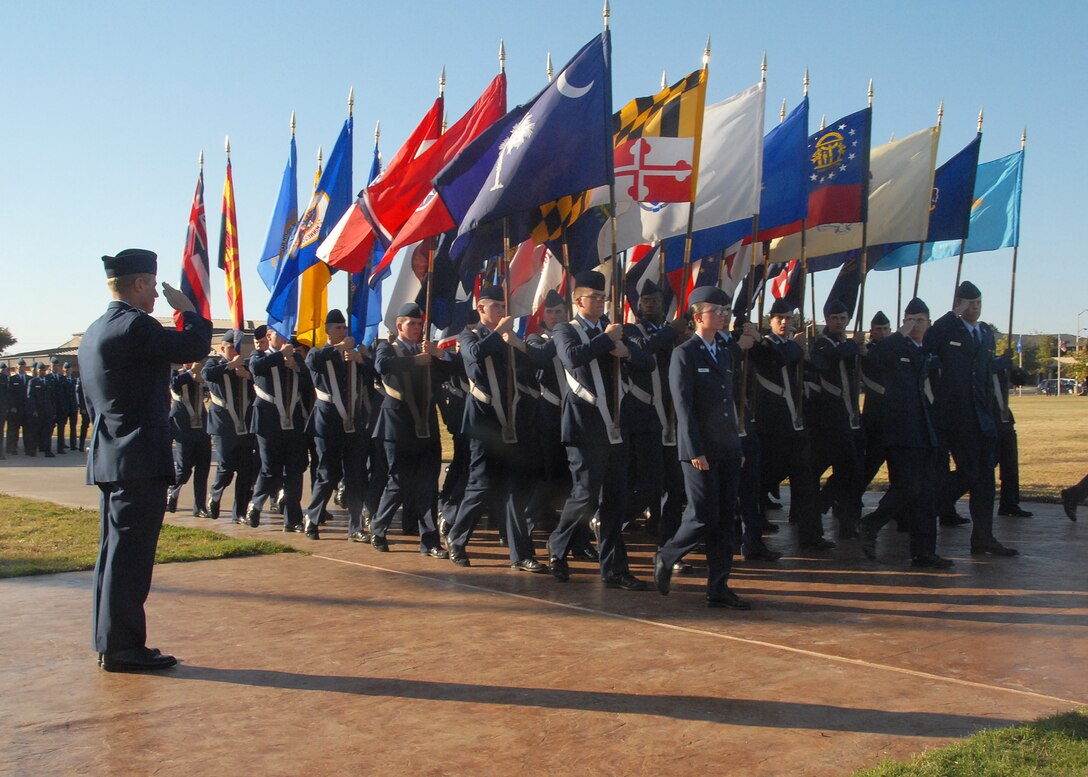 Col. Dave Petersen, left, commander of the 80th Flying Training Wing, renders a salute to the flags of the 50 United States during a parade Nov. 1 at the base parade grounds. (U.S. Air Force photo/Mike Litteken)