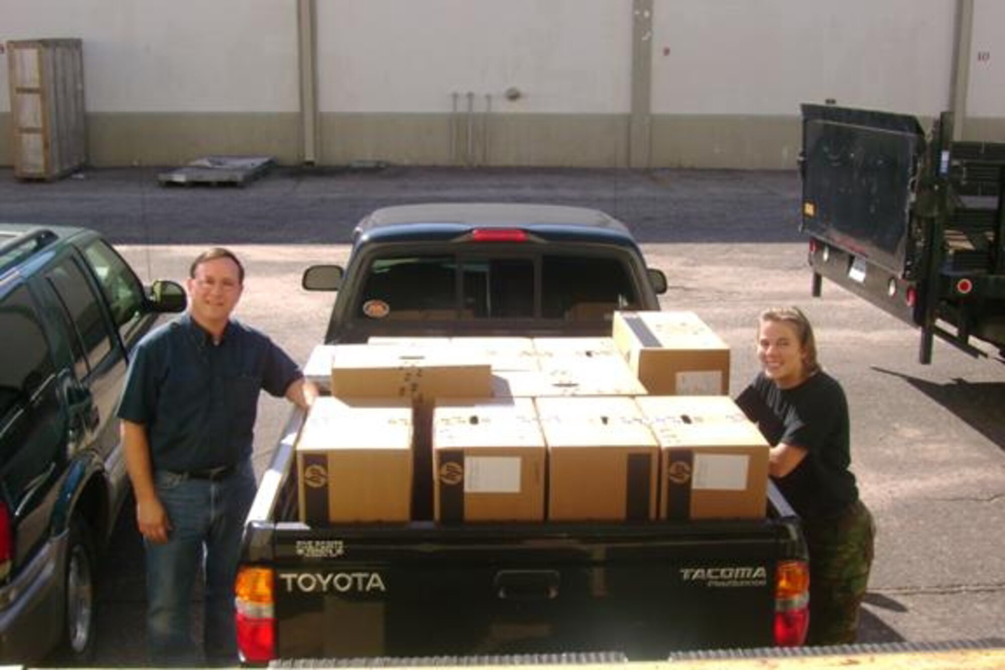 EGLIN AIR FORCE BASE, Fla. -- Tom Jones and Staff Sgt. Crystal Smith, both with the Air Armament Center staff judge advocate office, pick up 17 desktops and monitors, part of a shipment of 1,400 computer desktops, monitors and laptops purchased with the Air Force Way's End-of-Year Quarterly Enterprise Buy Program. The program allowed organizations within the 96th Air Base Wing to pool their resources together to make a large consolidated computer purchase. (U.S. Air Force courtesy photo)