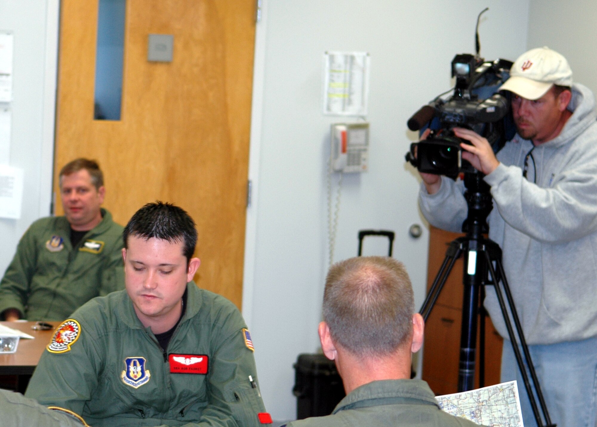 GRISSOM AIR RESERVE BASE, Ind., -- Media from Wane-TV, out of Fort Wayne, Ind., visited Grissom to take part in an inflight rufueling mission. The media were able to follow the flight crew, from the 74th Air Refueling Squadron, through the whole process. Here the media is recording the pre-flight briefing. (U.S. Air Force photo/ Senior Airman Carl Berry)