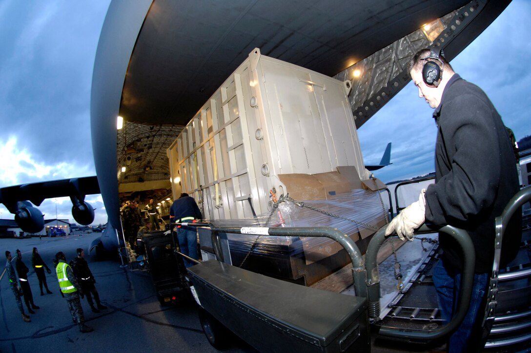 John Bamburg operates a 60K Loader to put Maggie, an African elephant, aboard a C-17 Globemaster III Nov. 2. Maggie was transported from Elmendorf to Travis AFB, Calif. The entire operation from Alaska to her new home at the Performing Animals Welfare Society in California was expected to take approximately 12 hours. (U.S. Air Force photo/Tech. Sgt. Keith Brown)