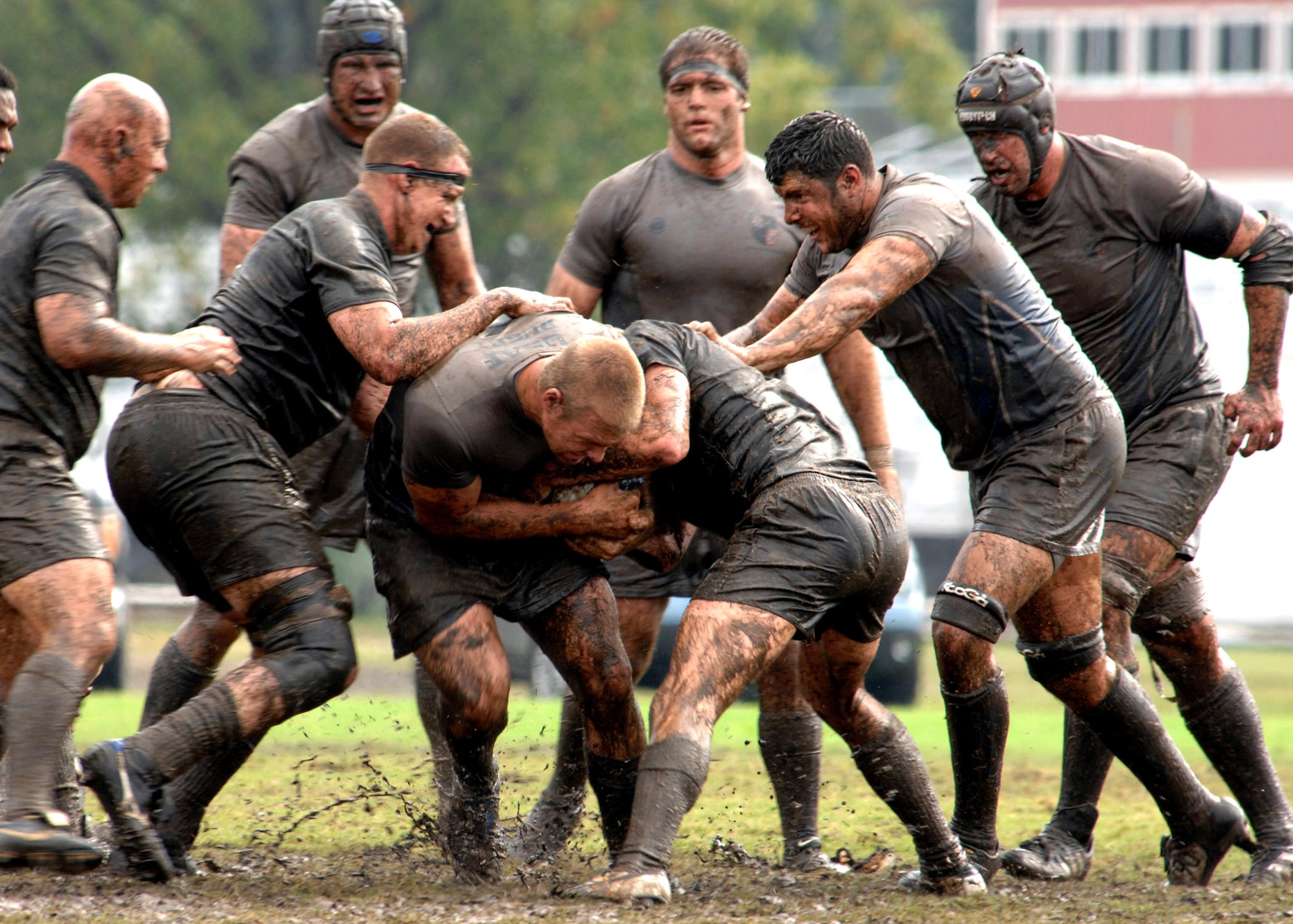 Air Force rugby player Ryan Dombrock is tackled while his teammates prepare to ruck the Army defenders during the 2007 Armed Forces Rugby Tournament Oct. 27 at Marine Corps Base Camp Lejeune, N.C.  The Airmen won 22-5 for a fourth consecutive championship victory. (U.S. Air Force photo/Airman 1st Class Greg C. Biondo)