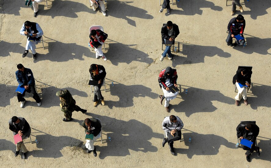 With clipboards in hand, prospective cadets wait to take the entrance exam for the Afghan National Army Academy in Kabul Oct 25.  More than 1800 came here to test, all hoping to be one of the approximately 300 chosen for the new freshman class.  (U.S. Air Force photo/Staff Sgt. Brian Ferguson)
