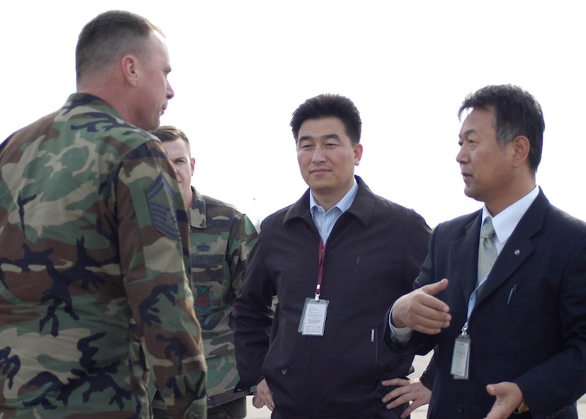 KUNSAN AIR BASE, South Korea-- Senior Master Sgt. Dean Turner and Tech. Sgt. Jason Rosenbaum, 8th Civil Engineering Squadron fire department listen to Korean Airline representative talked about evacuation procedures here Oct. 29.  The fireman along with emergency medical personnel were trained at Gunsan City Airport how to evacuate people from the civilian aircraft. (U.S. Air Force photo by Staff Sergeant Araceli Alarcon)
