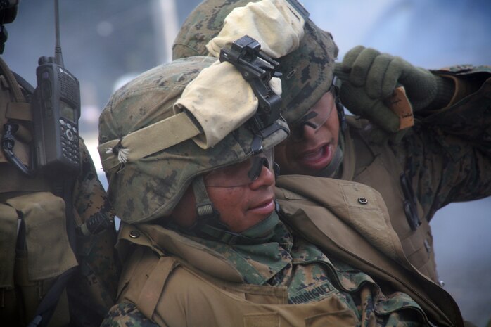 A Marine with C Company, Battalion Landing Team 1st Battalion, 6th Marine Regiment carries a simulated casualy at the Military Operation in Urban Terrain facility here.  The facility was rigged with mock explosions and bloody casualties to allow Marine to train in the most life-like scenarios possible