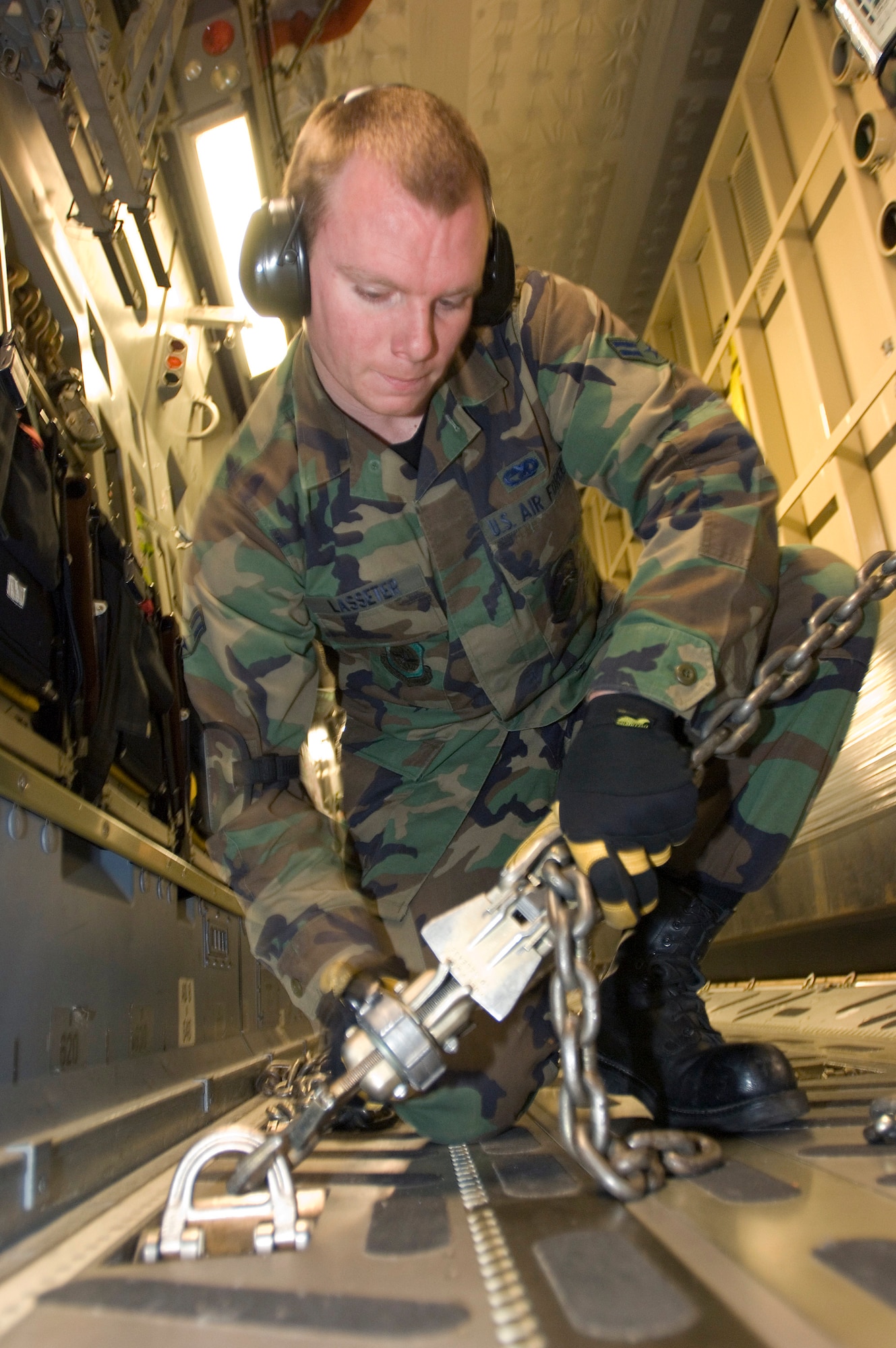 ELMENDORF AIR FORCE BASE, Alaska -- Airman 1st Class Michael Lasseter, 732nd Air Mobility Squadron, helps secure the crate carrying Maggie the Elephant to the floor of the C-17 that carried her to her new home in California. (U.S. Air Force Photo by Tech. Sgt. Keith Brown)