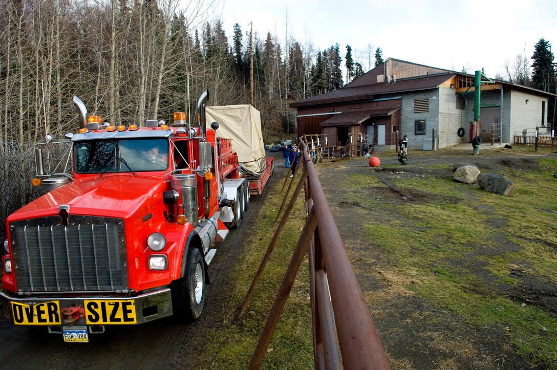 ANCHORAGE, Alaska -- The truck used to transport Maggie, an African elephant, departs the Alaska Zoo heading for Elmendorf Air Force Base. Maggie, who had been at the zoo since 1983, was transported via a C-17 to the Performing Animals Welfare Society in California. (U.S. Air Force Photo by Airman 1st Class Jonathan Steffen)