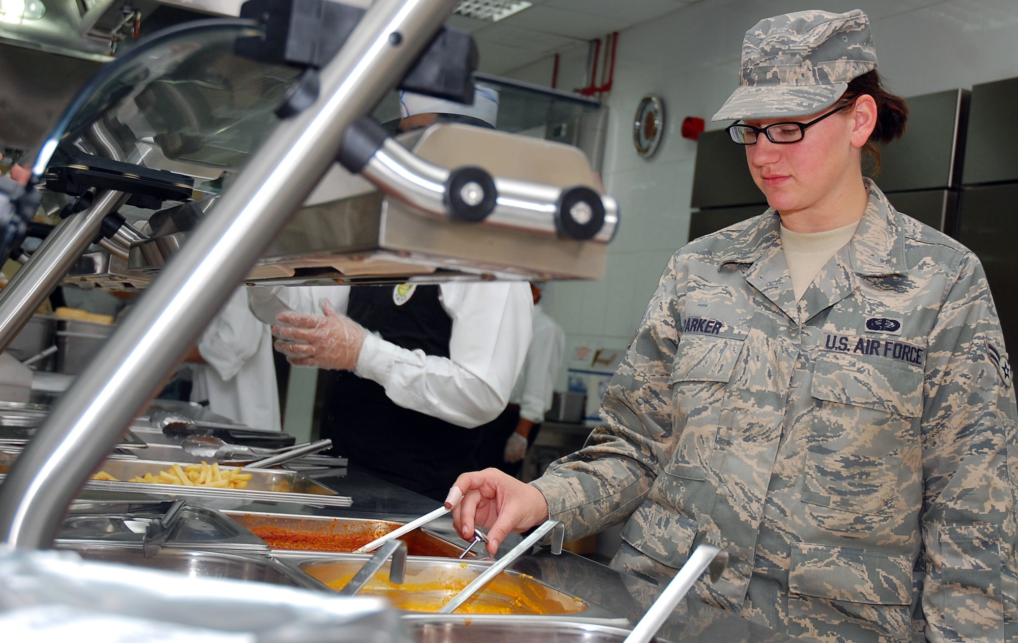 SOUTHWEST ASIA -- Airman 1st Class Katherine Parker, 386th Expeditionary Services Squadron food services specialist, performs a quality assurance temperature check Nov. 2 here.  Airman Parker is deployed from Minot AFB., N.D.  (U.S. Air Force photo by Staff Sgt. Tia Schroeder)