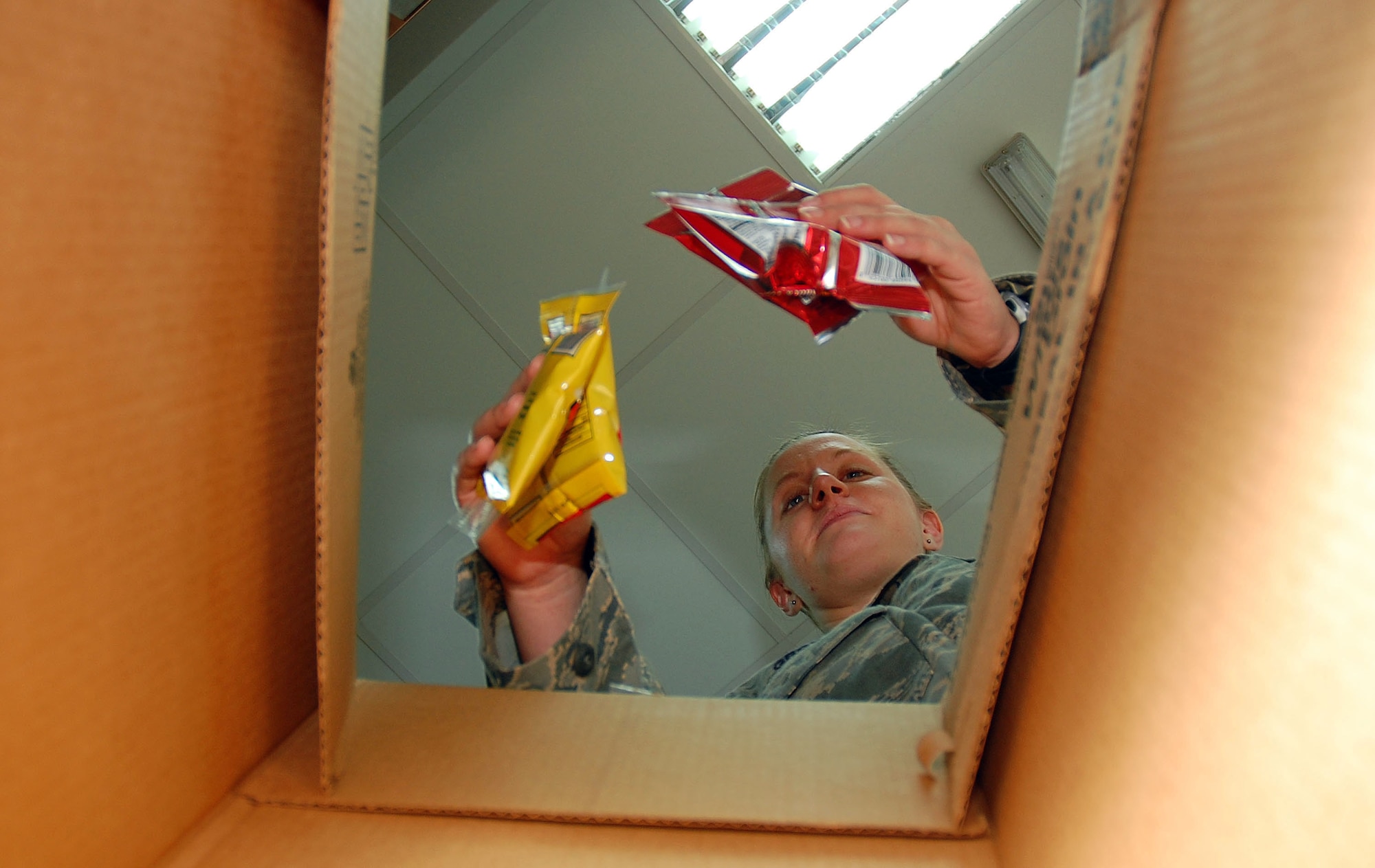 SOUTHWEST ASIA -- Airman 1st Class Kristen Grow, 386th Expeditionary Services Squadron food services specialist, prepares a flight meal for crew members Nov. 2 here.  Airman Grow is deployed from Barksdale AFB., La.  (U.S. Air Force photo by Staff Sgt. Tia Schroeder)