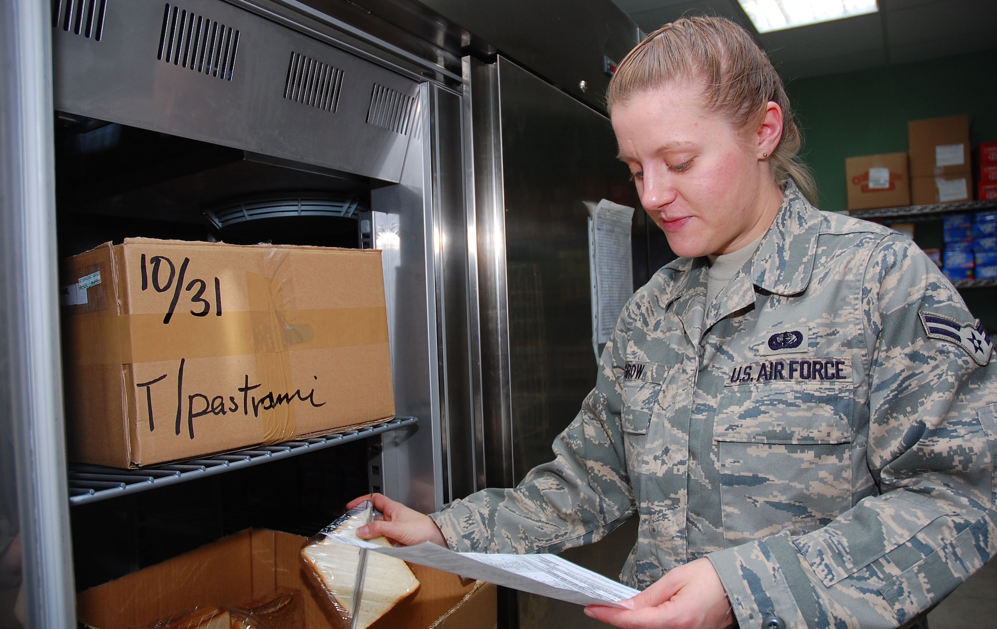 SOUTHWEST ASIA -- Airman 1st Class Kristen Grow, 386th Expeditionary Services Squadron food services specialist, conducts a flight meal inventory Nov. 2 here.  Airman Grow is deployed from Barksdale AFB., La.  (U.S. Air Force photo by Staff Sgt. Tia Schroeder)