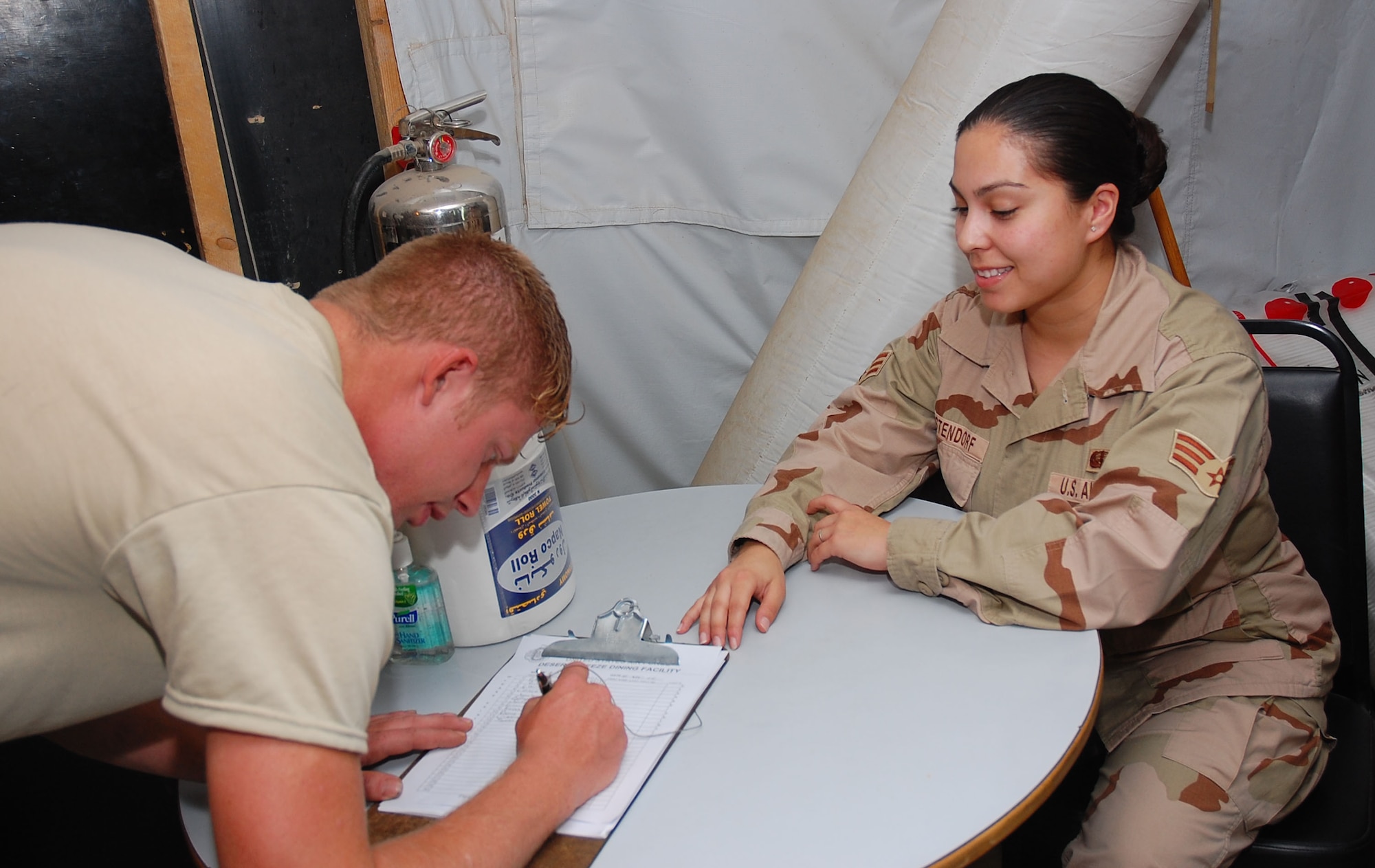 SOUTHWEST ASIA -- Senior Airman Katrina Westendorf, 386th Expeditionary Services Squadron food services specialist, ensures proper accountability of servicemembers utilizing facility Nov. 2 here.  Airman Westendorf is deployed from Whiteman AFB., Mo.  (U.S. Air Force photo by Staff Sgt. Tia Schroeder)
