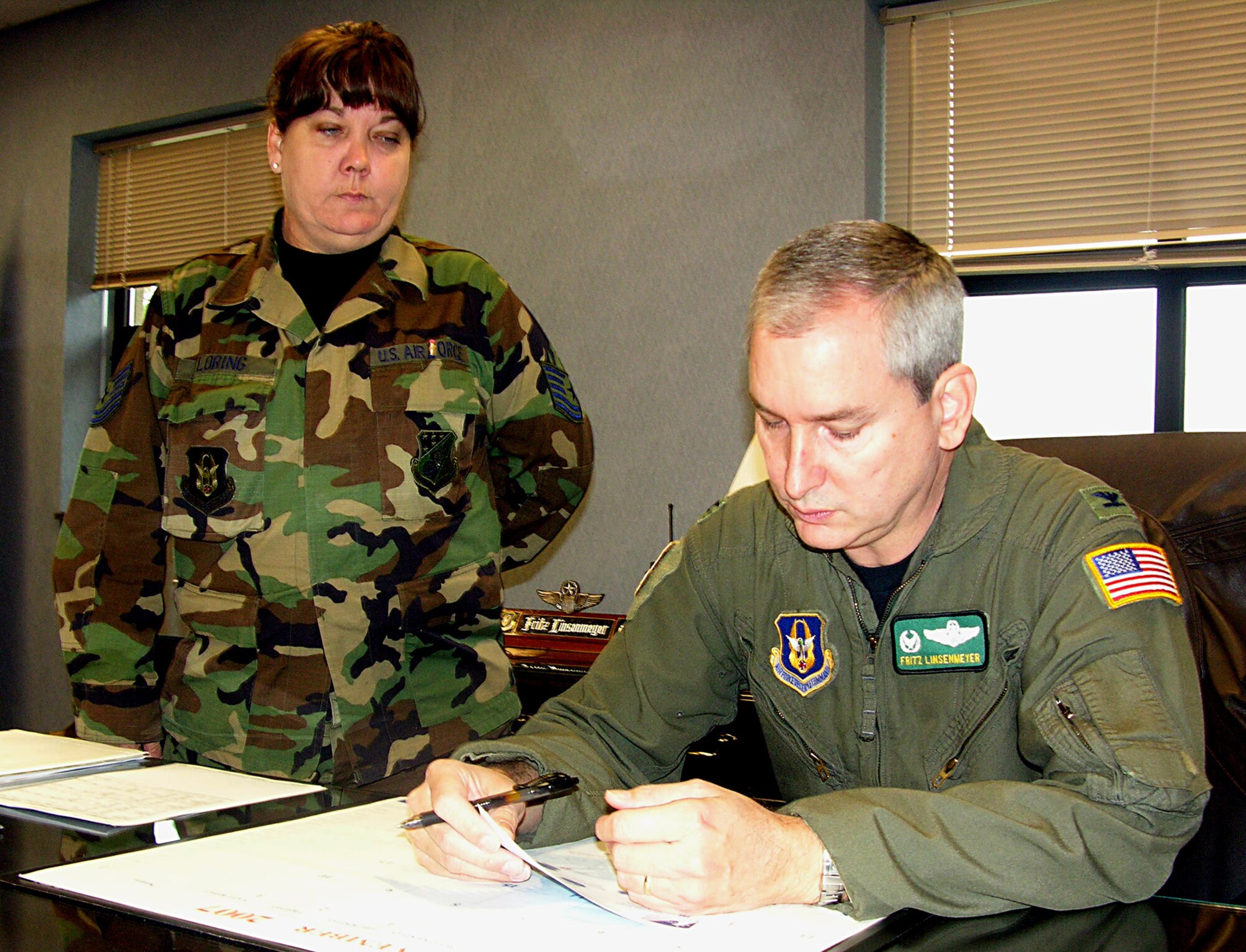 SEYMOUR JOHNSON AIR FORCE BASE, N.C.-- Col. Fritz Linsenmeyer, 916th Air Refueling Wing commander, signs his Combined Federal Campaign form in the presence of Tech. Sgt. Sharon Loring, wing CFC coordinator. Col. Linsenmeyer made his contributions to charity during the November unit training assembly. Donations can be made through the December drill. See your squadron point of contact or Tech. Sgt. Loring for more information.