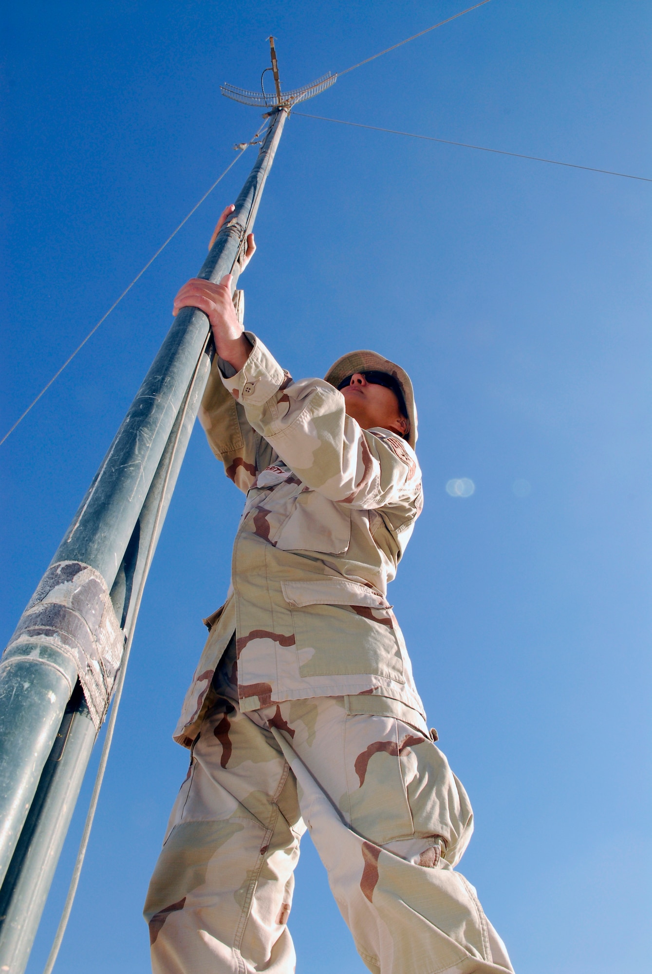 BALAD AIR BASE, Iraq -- Staff Sgt. Rudaina Altikrity, 332nd Expeditionary Mission Support Group Detachment 1 Mayor Cell Armed Forces Network technician, adjusts an AFN antenna in a housing area. Sergeant Altikrity handles all AFN requests for LSA Anaconda, from hooking up the signal to trouble shooting any problems with reception. Sergeant Altikrity is deployed from Ramstein Air Base, Germany.   (U.S. Air Force photo/Staff Sgt. Joshua Garcia)

