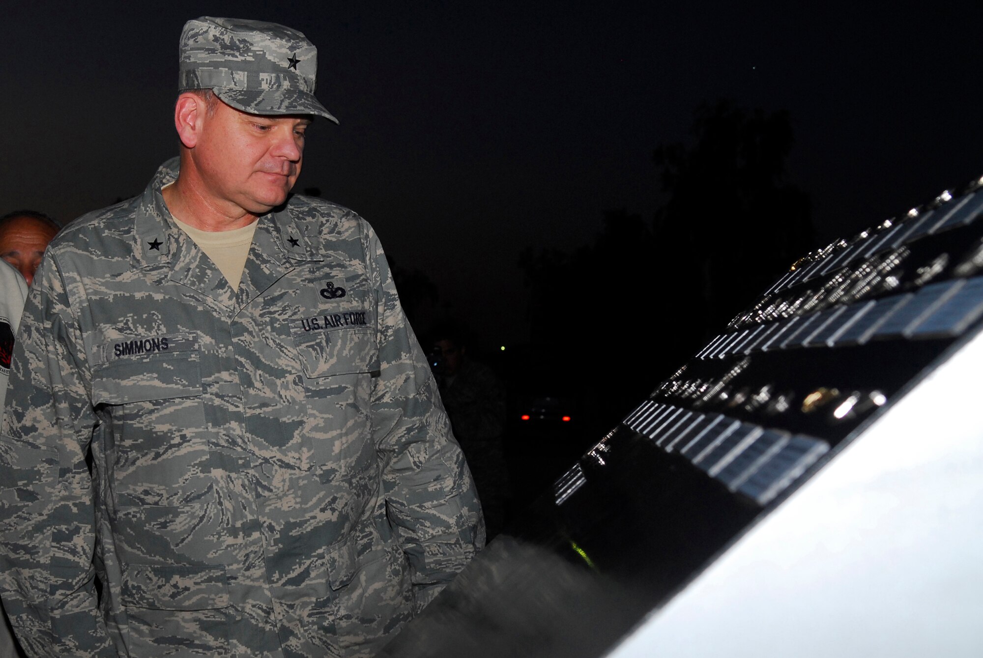 BALAD AIR BASE, Iraq -- Brig. Gen. Dana Simmons, Air Force Office of Special Investigations commander, reads the names of his three Airmen that were added to the Fallen Airman Memorial here, Nov. 4. Special Agents Thomas Crowell, David Wieger and Nathan Schuldheiss of AFOSI Expeditionary Detachment 2411 died Nov. 1, of wounds sustained from an improvised explosive device. (U.S. Air Force photo/Staff Sgt. Joshua Garcia)