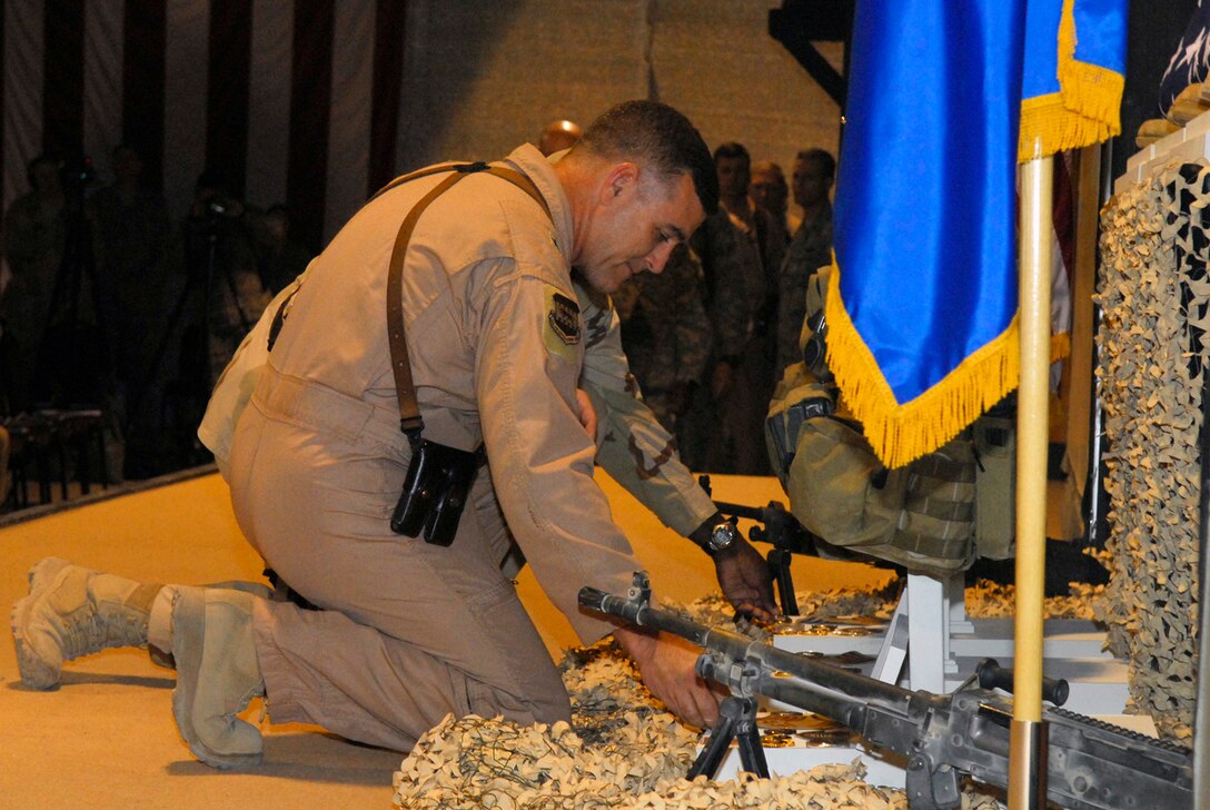 BALAD AIR BASE, Iraq -- Brig. Gen. Burt Field, Commander 332nd Air Expeditionary Wing commander, pays his final respects to Special Agents Thomas Crowell, David Wieger and Nathan Schuldheiss of the Air Force Office of Special Investigations Expeditionary Detachment 2411 during a memorial service here, Nov. 4.  A heroes display was erected for each special agent where personnel were able to pay their respects for the fallen Airmen. (U.S. Air Force photo/Staff Sgt. Joshua Garcia)