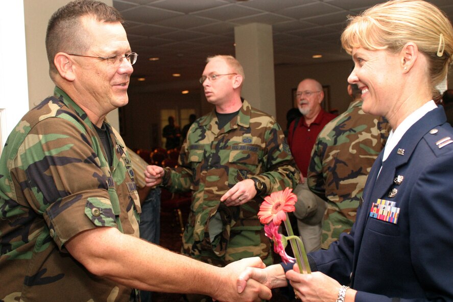 The special function room of the enlisted club burst at the seams for the assumption of command ceremony for Capt. Christy Shaw Nov. 3. Many of the guests waited in a long line to congratulate the new commander of the 482nd Fighter Wing Mission Support Squadron. Lt. Col. Tom Davis, chief of public affairs for the wing, was one of those offering congratulations and well wishes. (Air Force photo/Tech. Sgt. Paul Dean)
