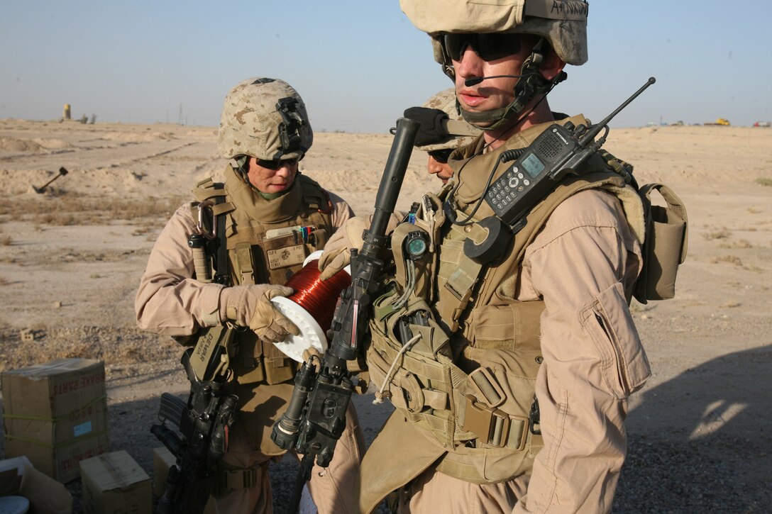 Staff Sgt. Brian Faulk (right) of Security Company, Combat Logistics Battalion 8, 2nd Marine Logistics Group (Forward) conducts a vehicle search during a security patrol outside of Fallujah Nov. 5. The 2nd MLG (Fwd) is currently deployed to Iraq?s Al Anbar Province. The unit provides logistical support to regimental combat teams throughout the entire province and is also in charge of providing medical care, maintenance and engineering capabilities.
