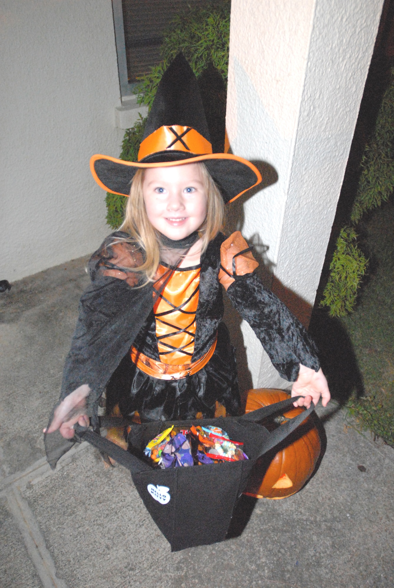 Anna Mills, daughter of Andrea and Senior Airman Terrance Thibideau, 18th Communications Squadron, holds out her bag of candy after a night of trick or treating Oct. 31, 2007. (U.S. Air Force photo/Airman 1st Class Kasey Zickmund)
