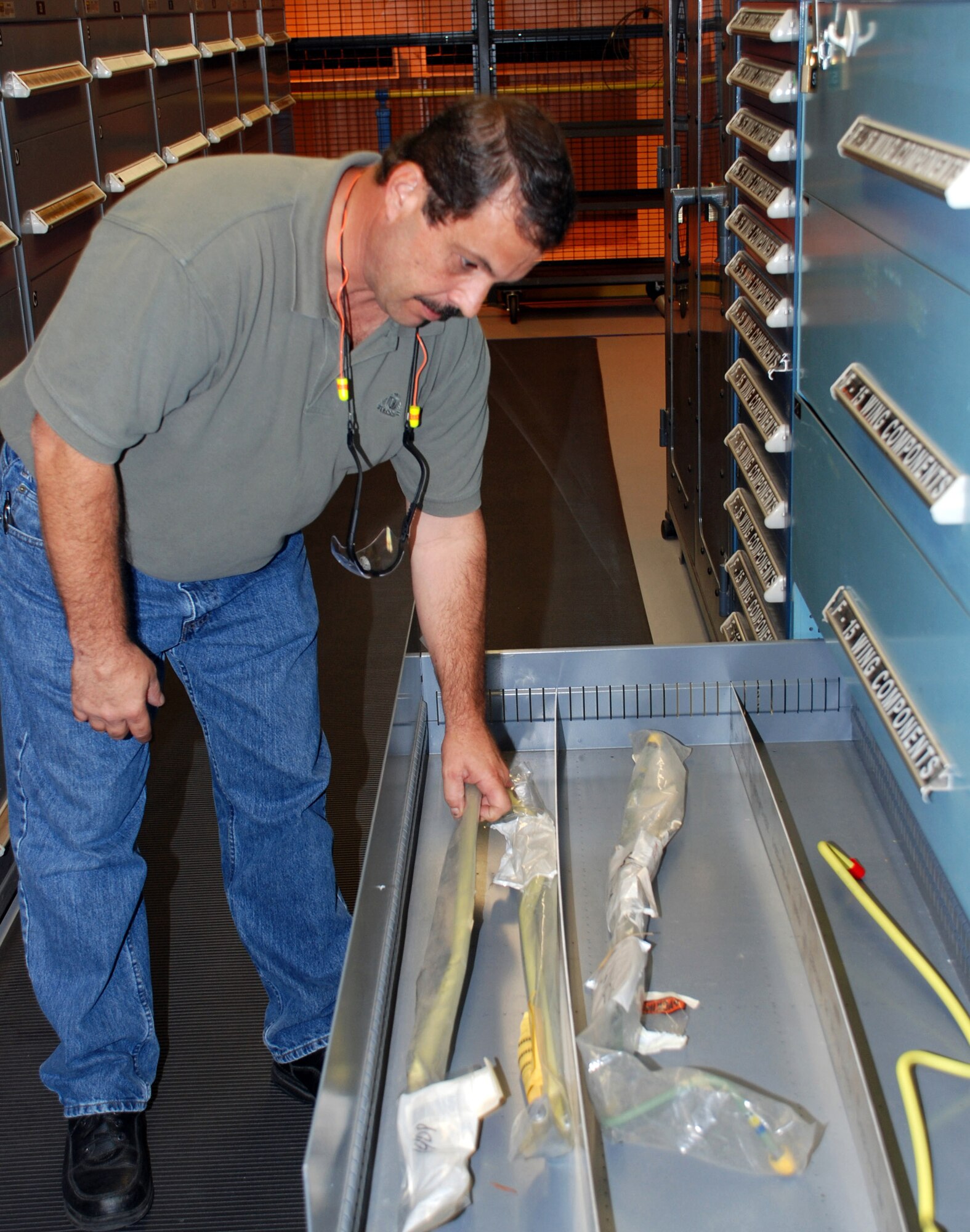 Marcel Baril, Defense Logistics Agency supportability specialist, looks over the print stuffer list that was sent from Air Force employees in the F-15 wing shop. The list contains items needed to refurbish a wing. (Defense Logistics Agency photo/Amy Clement) 
