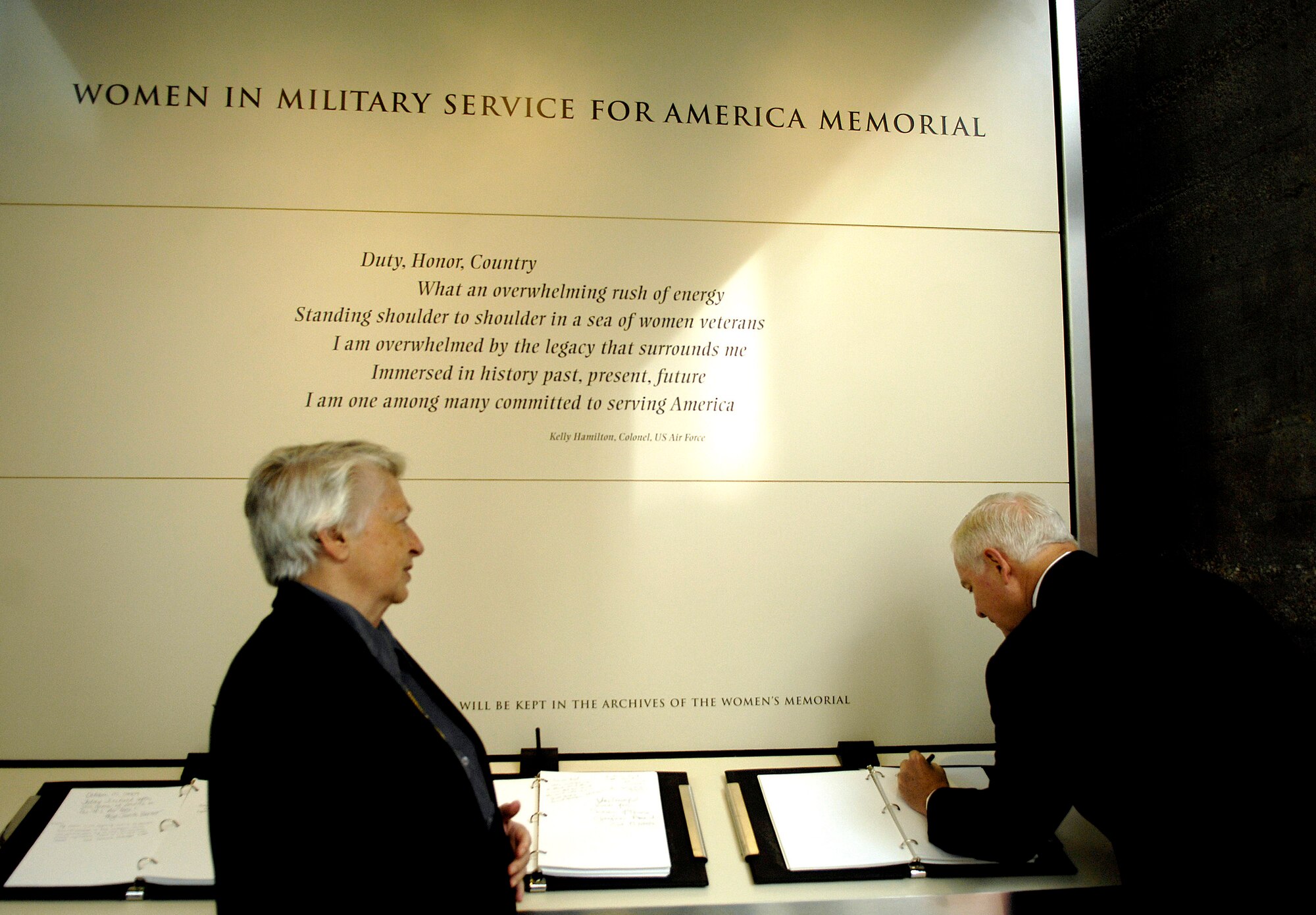 Secretary of Defense Robert M. Gates signs the guest book Nov. 3 as retired Brig. Gen. Wilma Vaught, president of Women in Military Service for America Memorial Foundation, looks on.  They were there the ceremony celebrating the 10th anniversary of the WIMSA Memorial at Arlington National Cemetery. (DOD photo/Cherie A. Thurlby)
